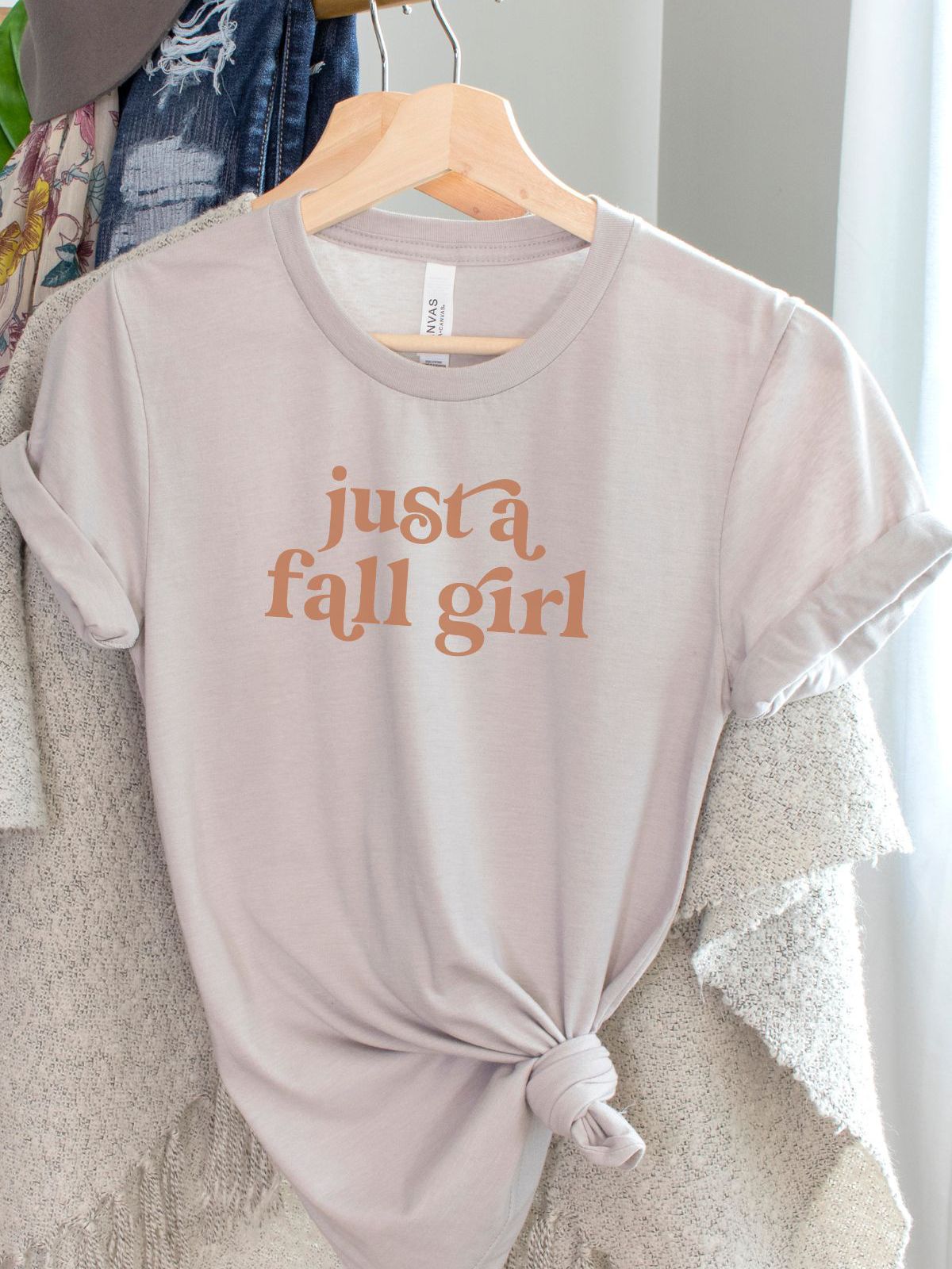 beige shirt with just a fall girl text