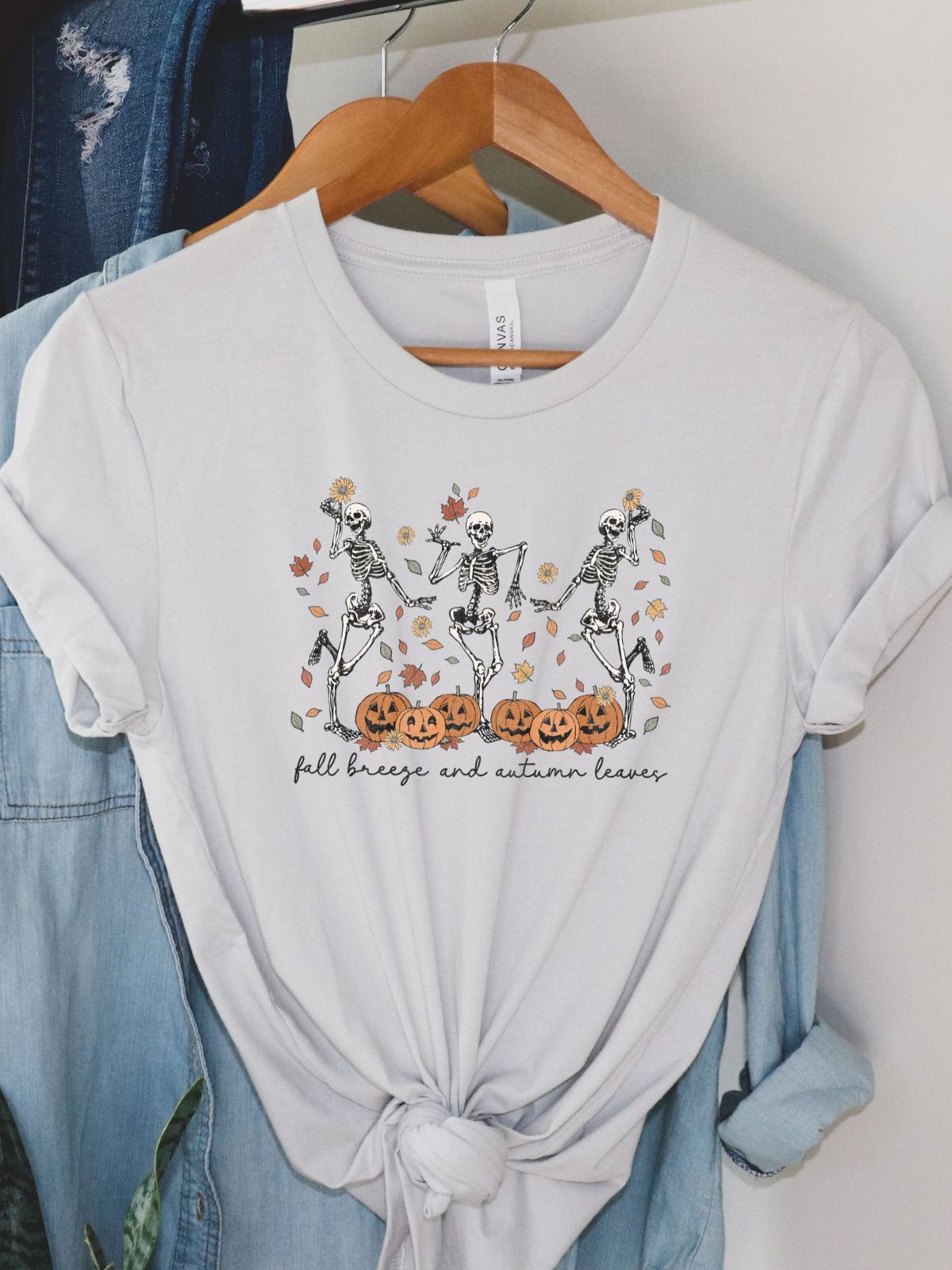 unisex t-shirt with skeletons and pumpkins design