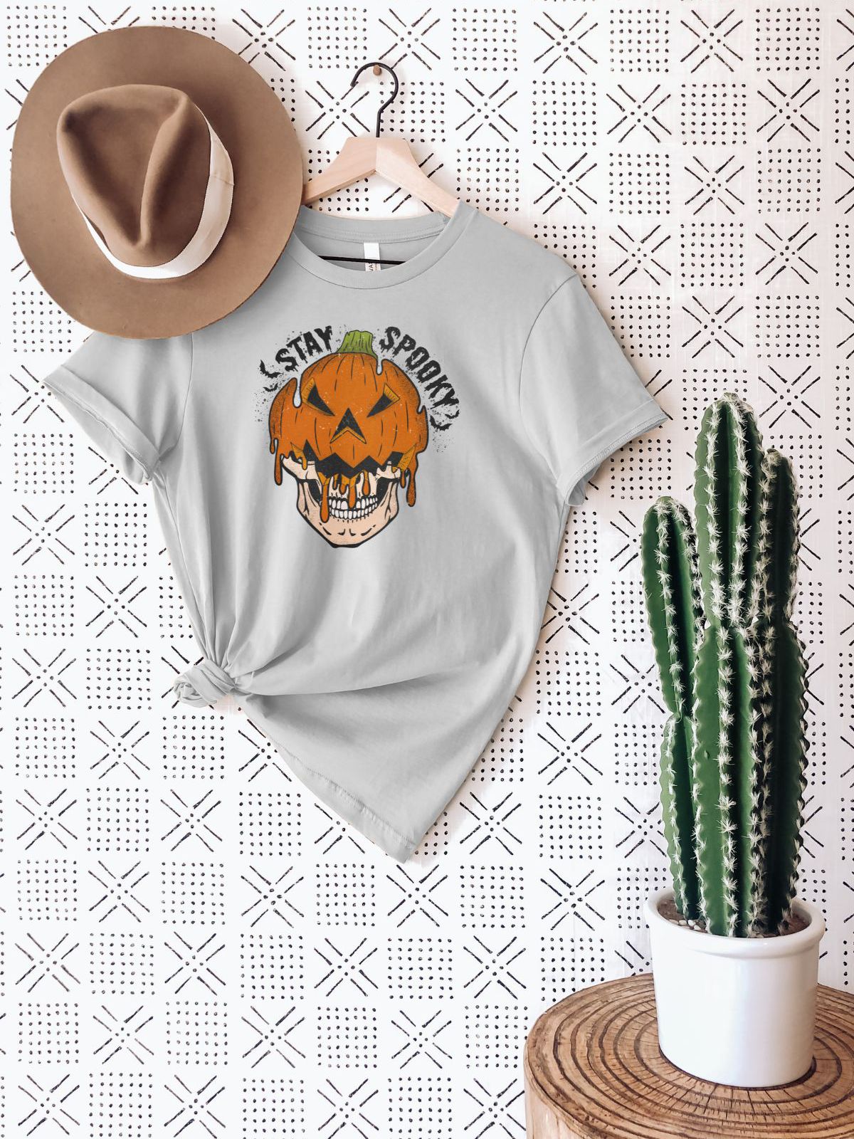 Stay Spooky pumpkin skull t-shirt hanging on wall