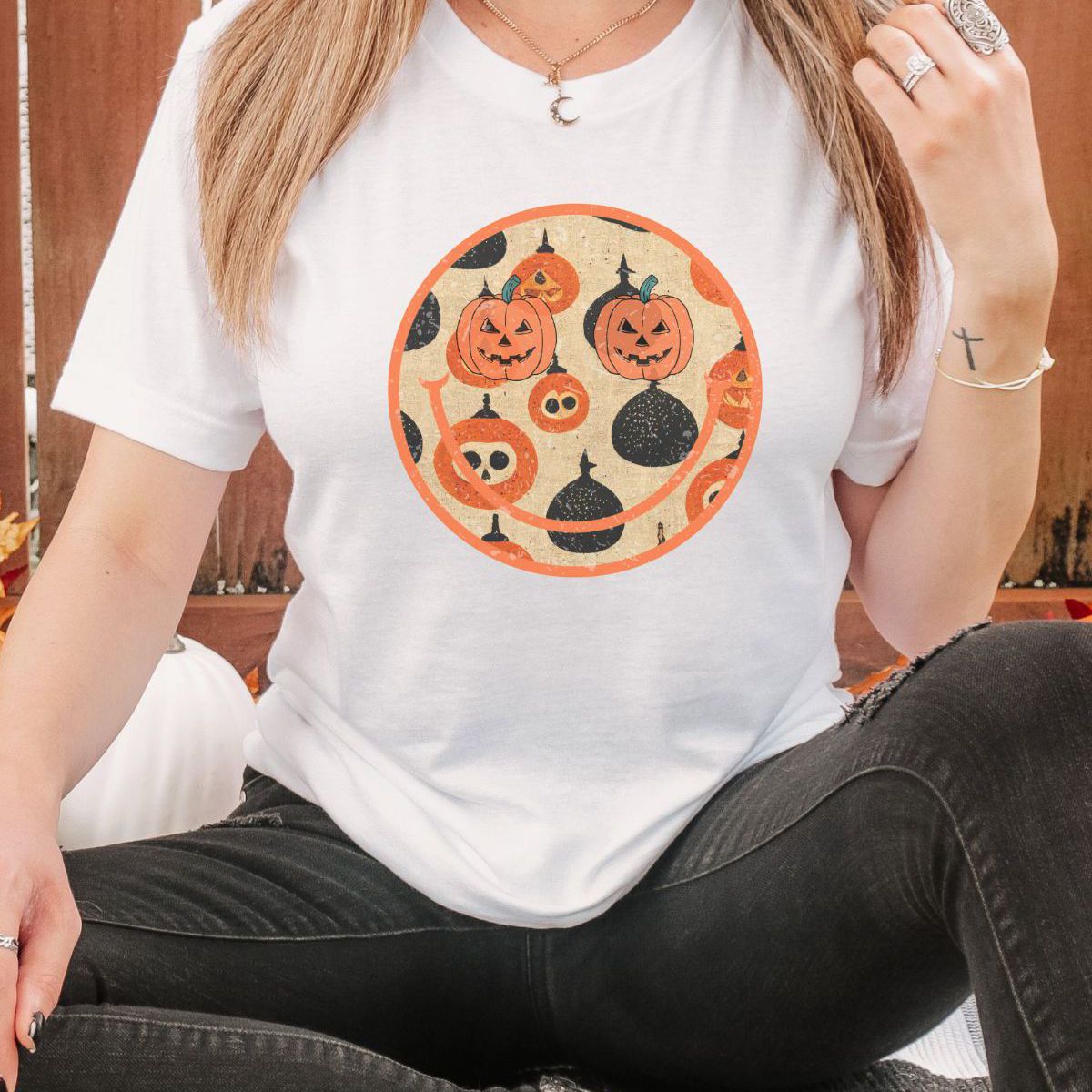woman wearing Halloween themed pumpkin face t-shirt