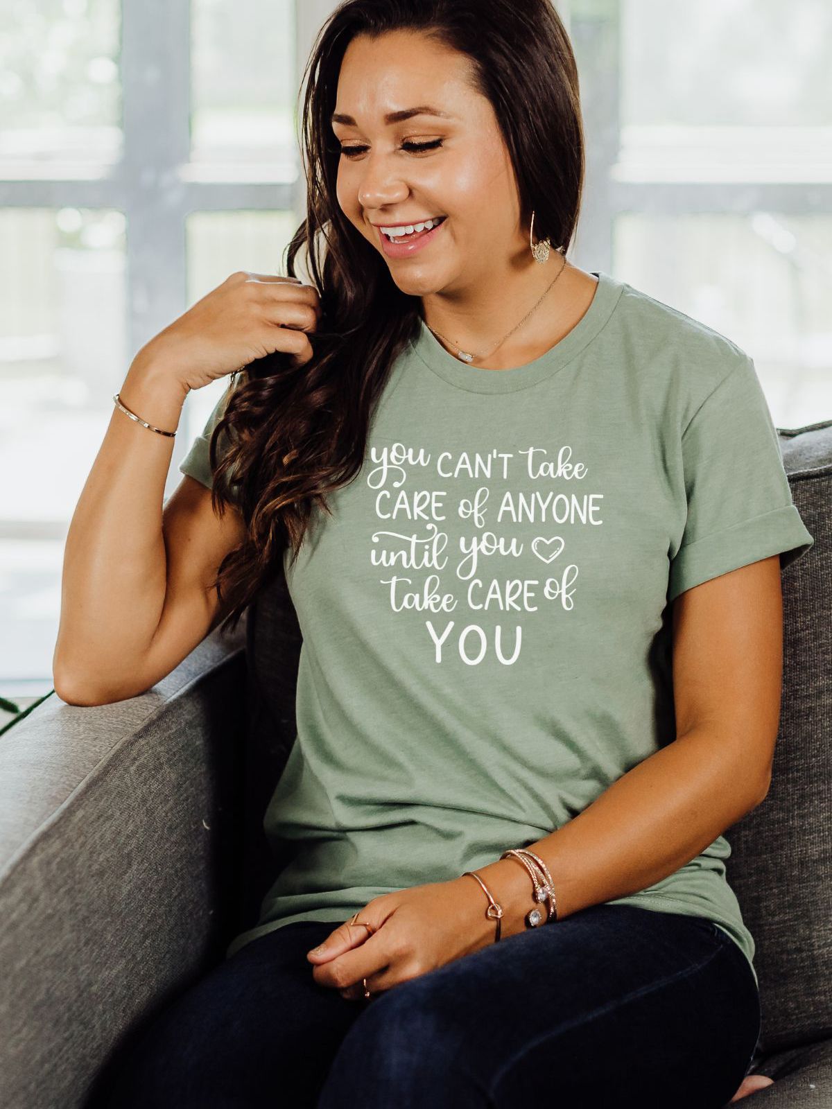 Woman wearing a green t-shirt with self care message