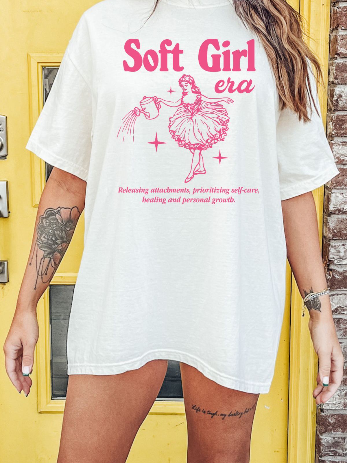 woman wearing a soft girl era t-shirt with pink design