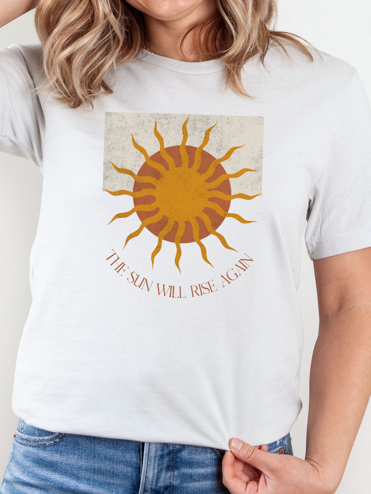 White t-shirt with sun design and text The Sun Will Rise Again
