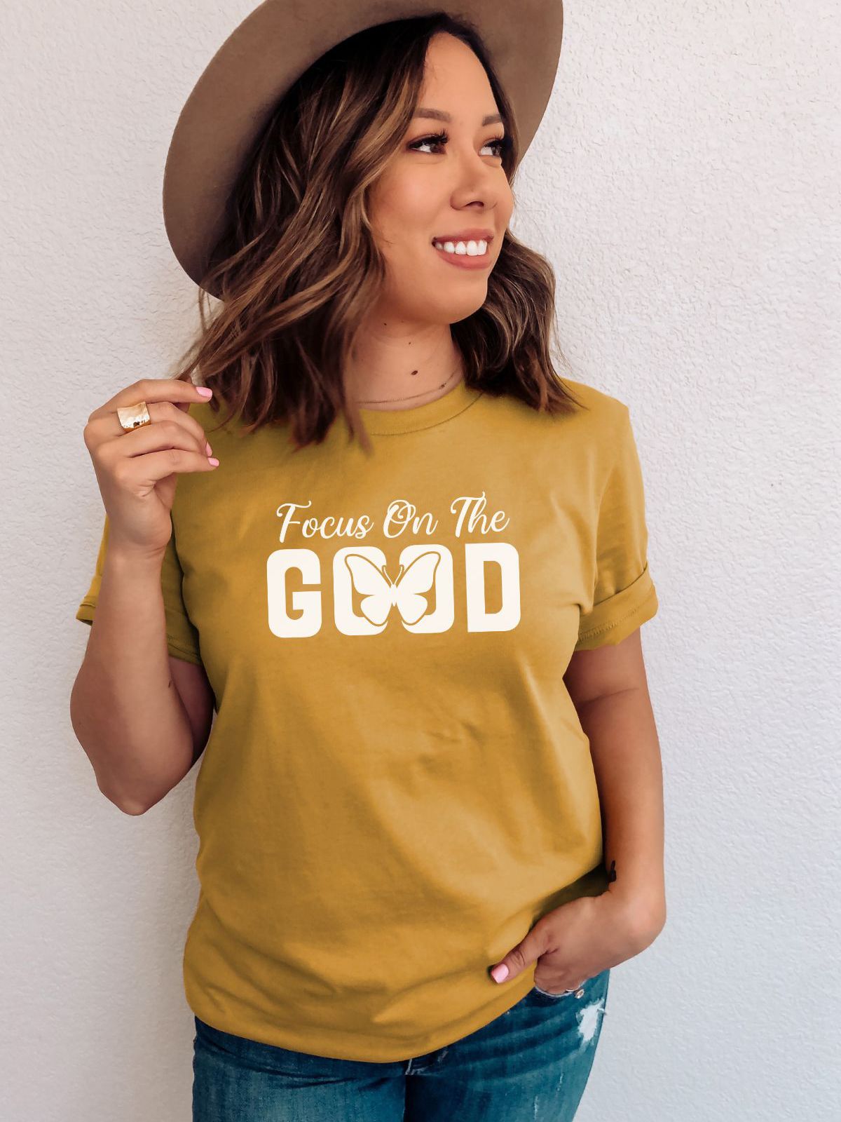woman wearing a yellow tee that says focus on the good