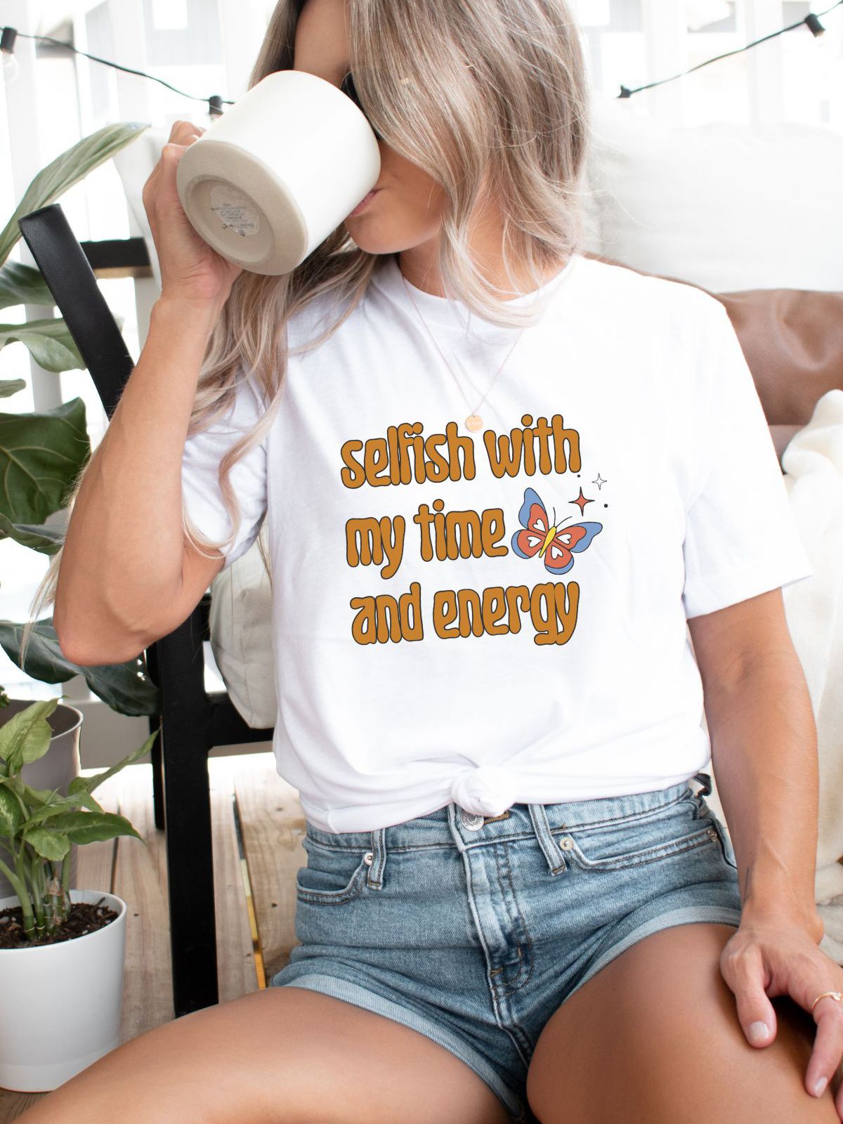 woman wearing selfish with my time and energy t-shirt