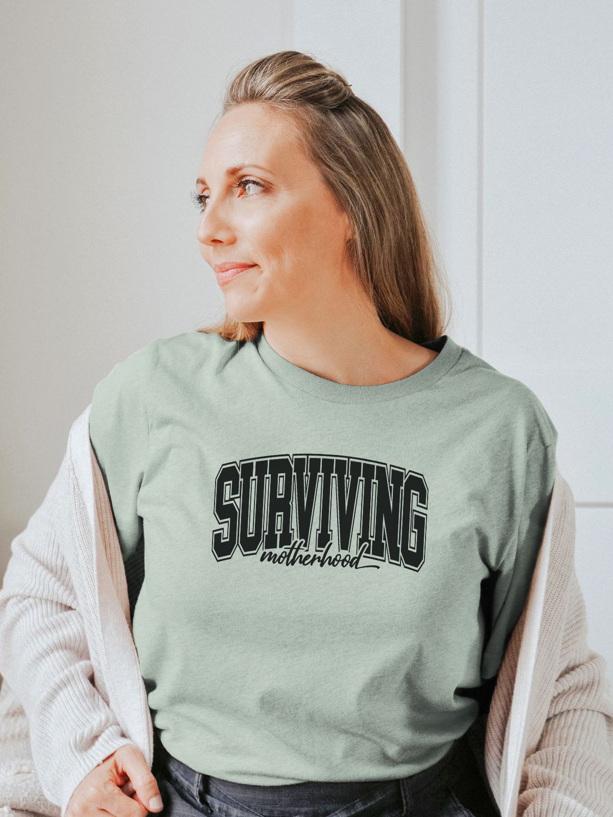 woman wearing Surviving Motherhood t-shirt