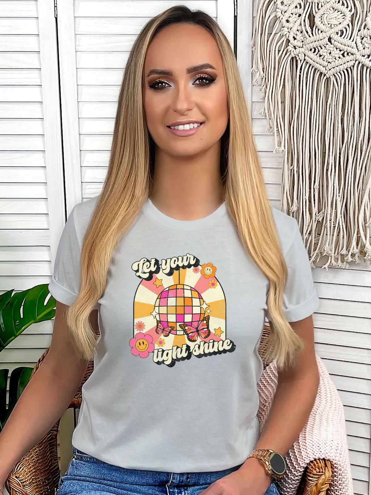 woman wearing Let Your Light Shine t-shirt with floral design