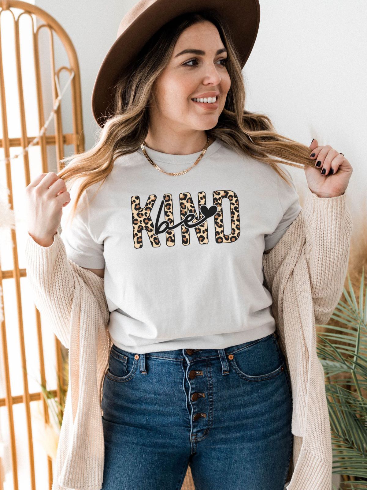 woman wearing be kind leopard print t-shirt