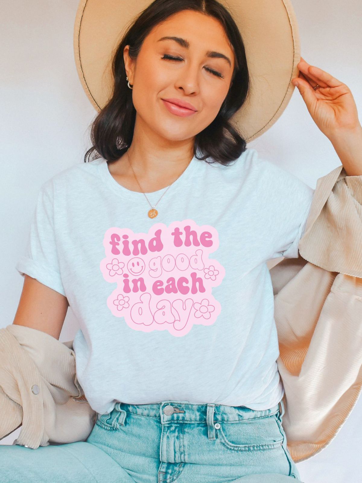 woman wearing a t-shirt with find the good in each day text