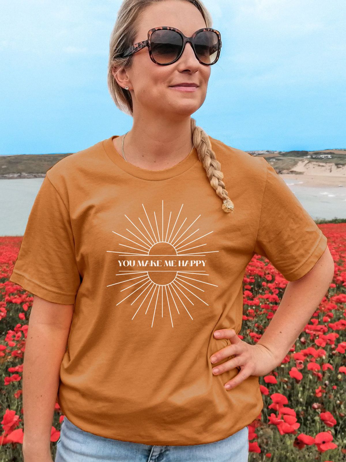 Woman wearing a You Make Me Happy T-shirt in a poppy field
