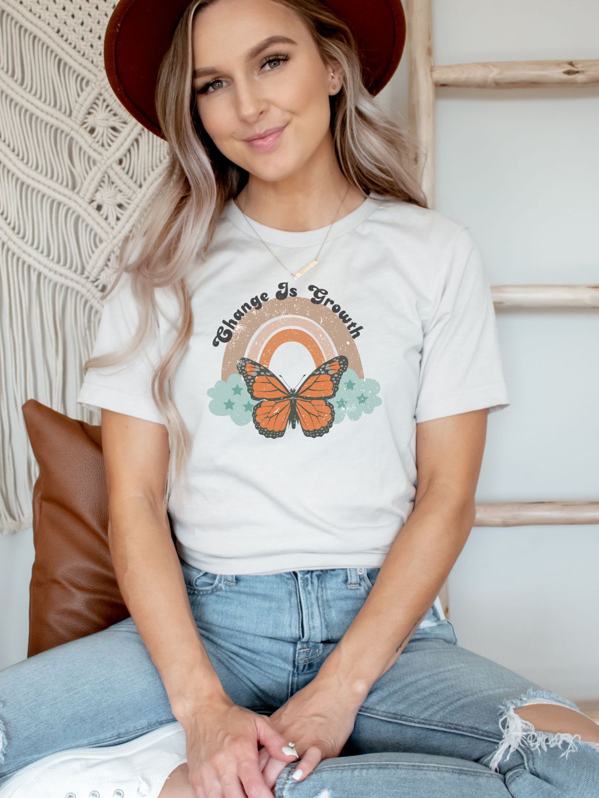 Woman wearing Change Is Growth t-shirt with butterfly design