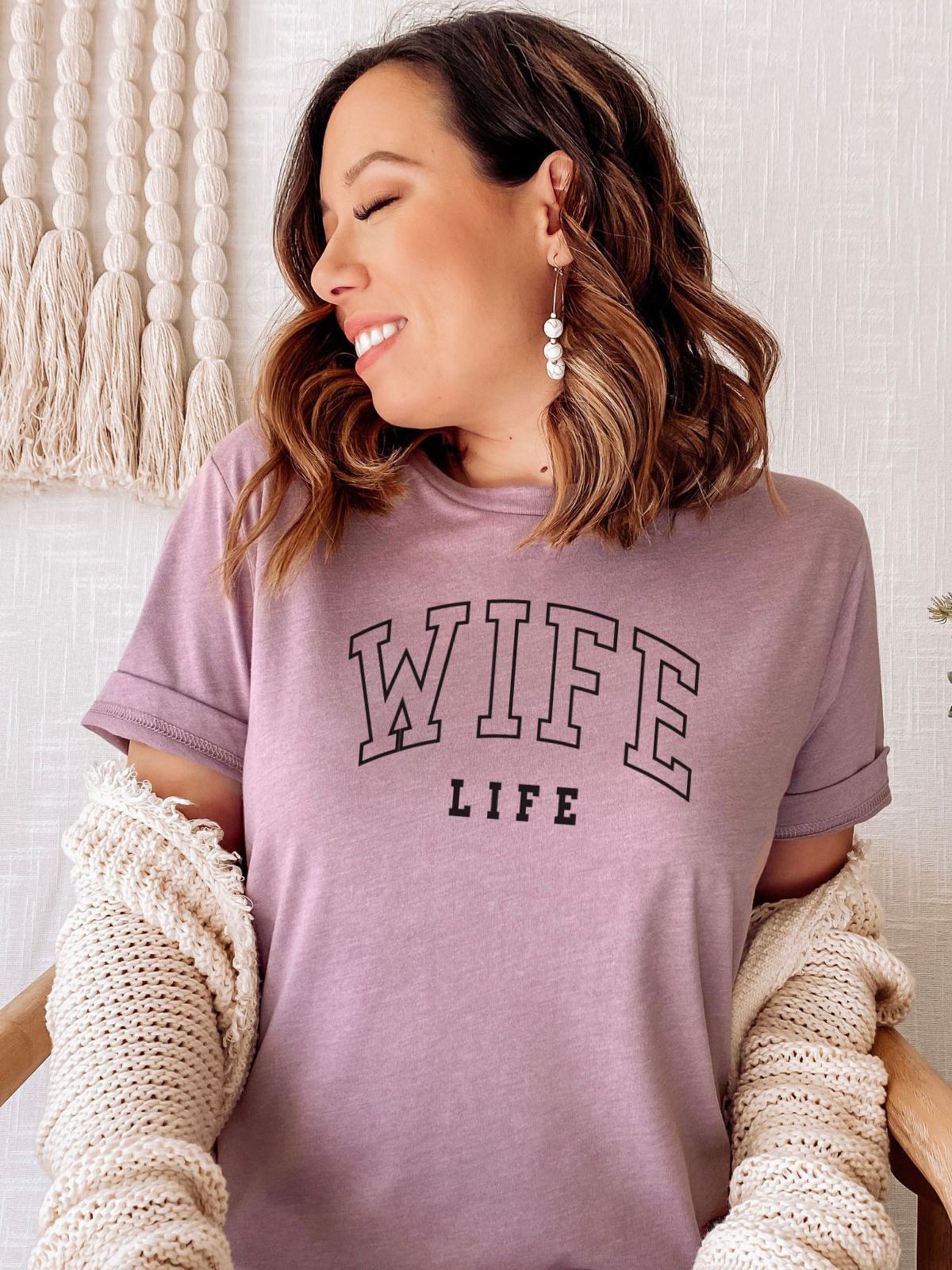 woman wearing Wife Life t-shirt in cozy setting