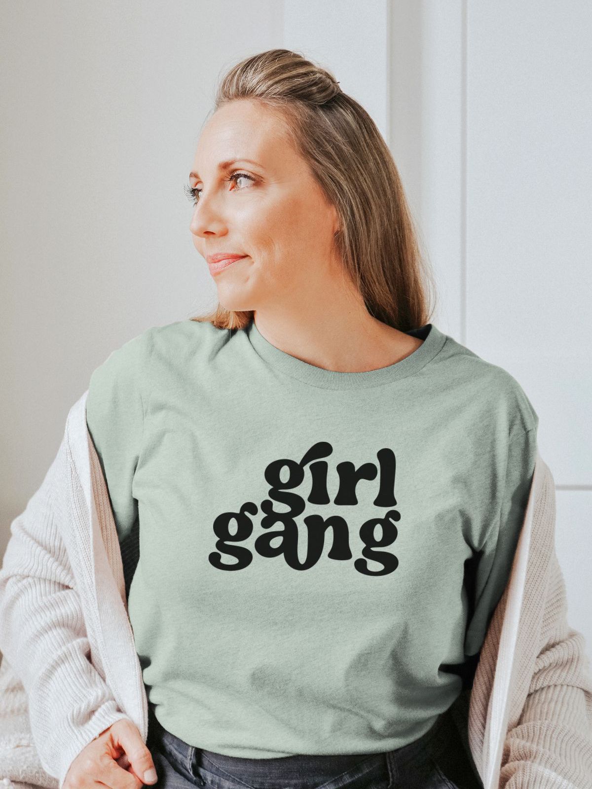 Woman wearing a Girl Gang t-shirt in light green
