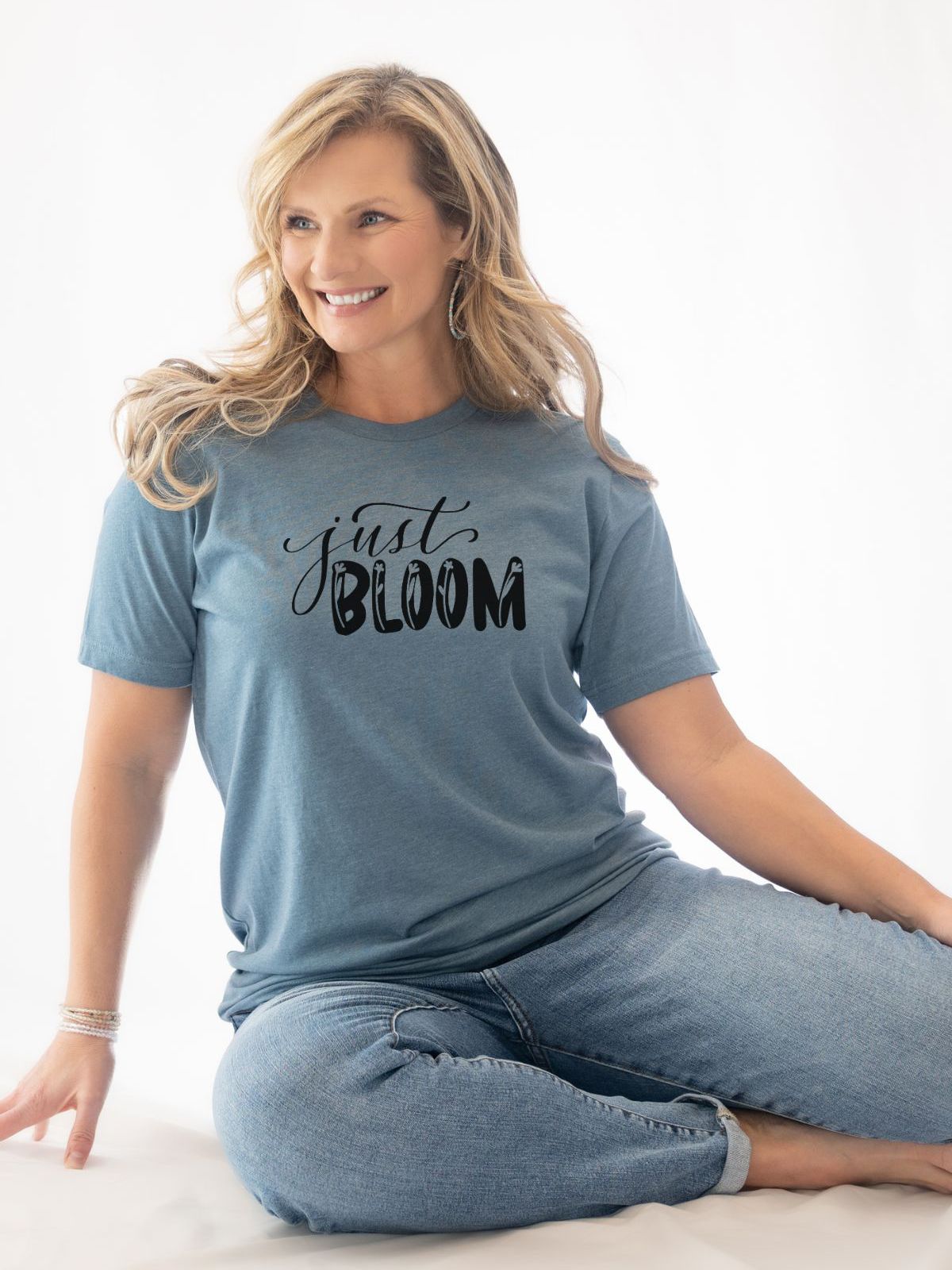 woman wearing just bloom t-shirt sitting