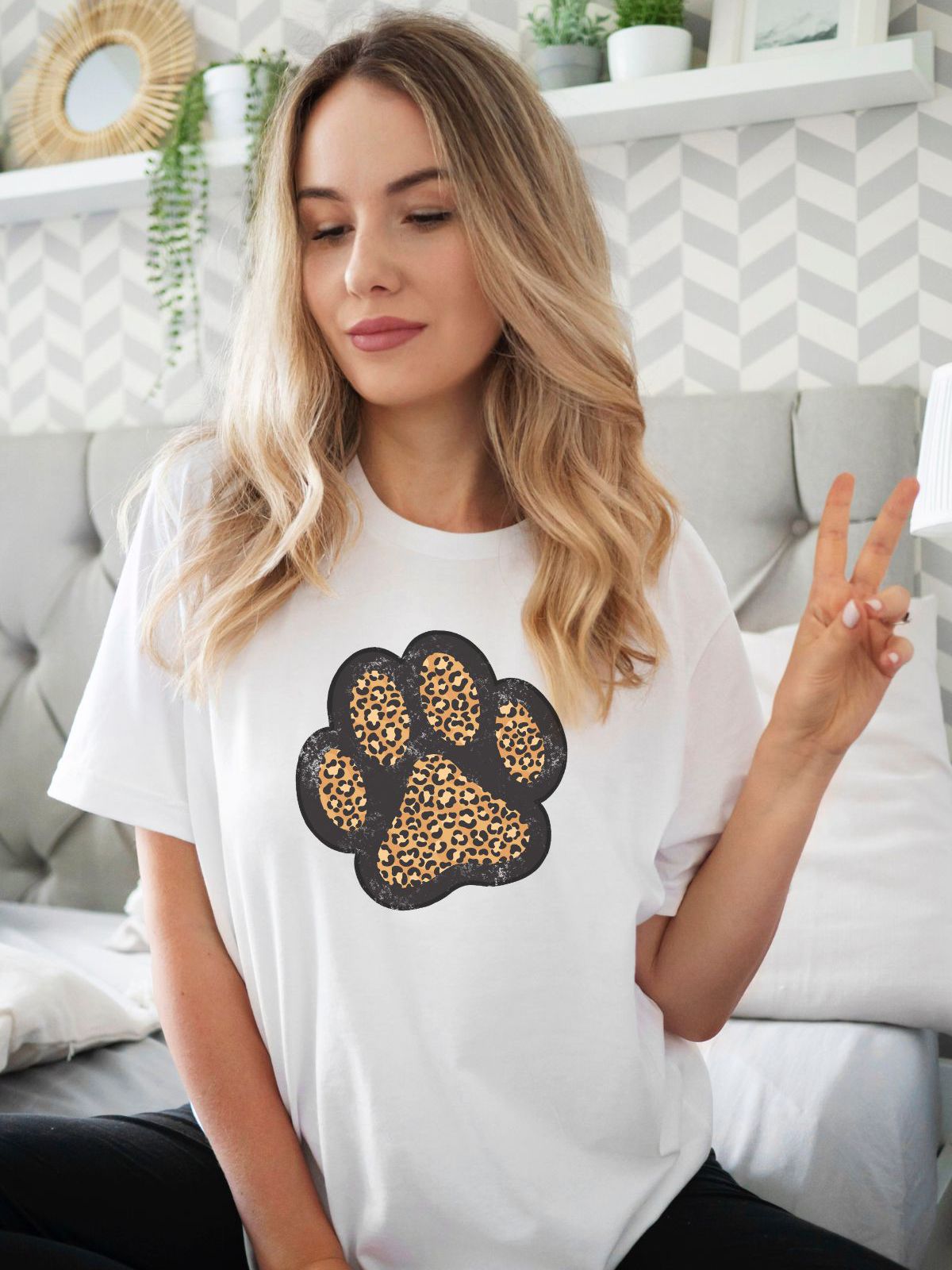 woman wearing white t-shirt with leopard print paw design