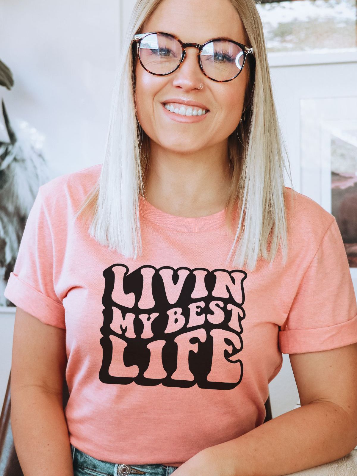 woman wearing pink t-shirt with livin my best life text