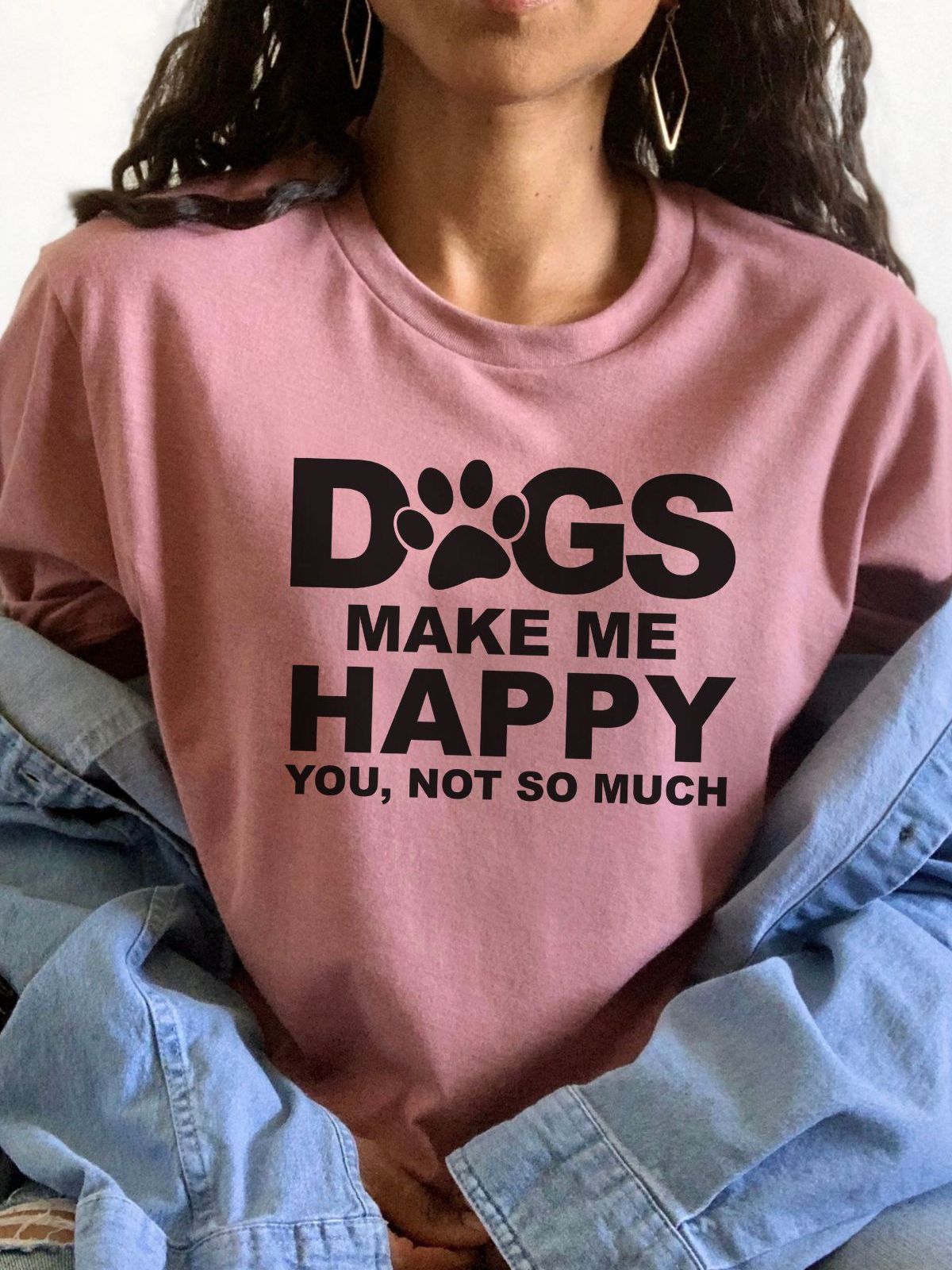 woman wearing a pink t-shirt with dogs make me happy text