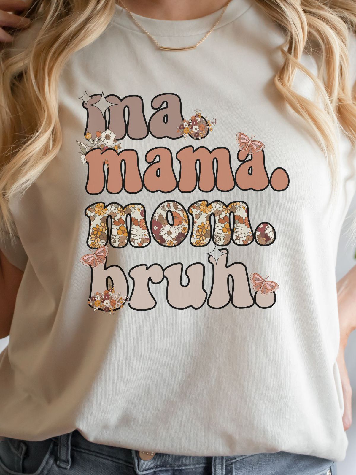 woman wearing a cream shirt with mama mom bruh text