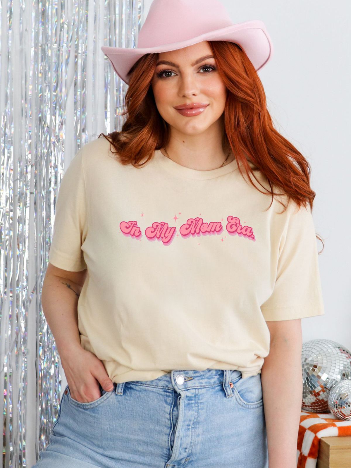 woman wearing In My Mom Era shirt with pink hat