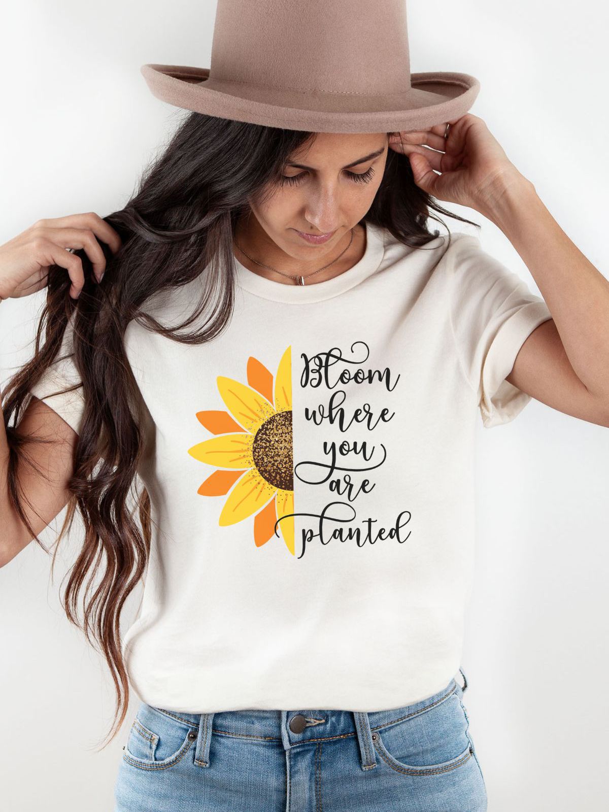 woman wearing a tshirt with sunflower and bloom where you are planted text