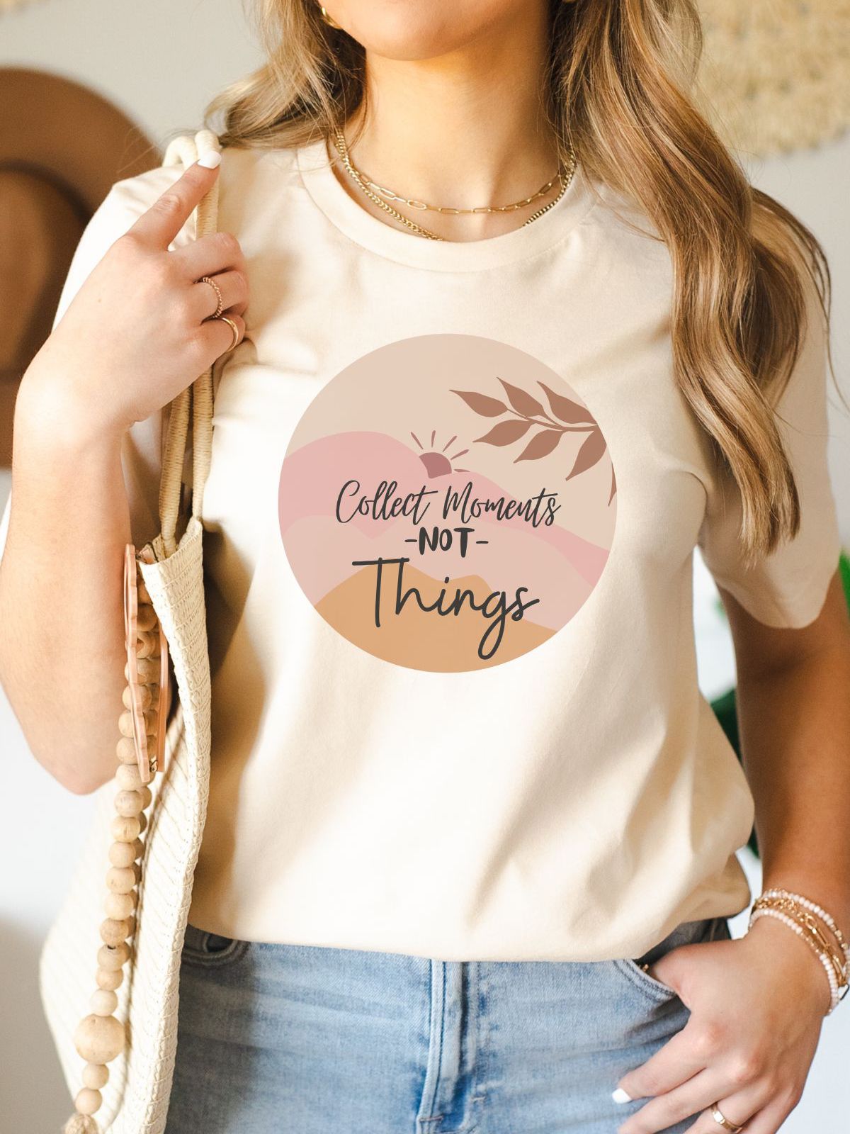woman wearing a beige t-shirt with collect moments not things design