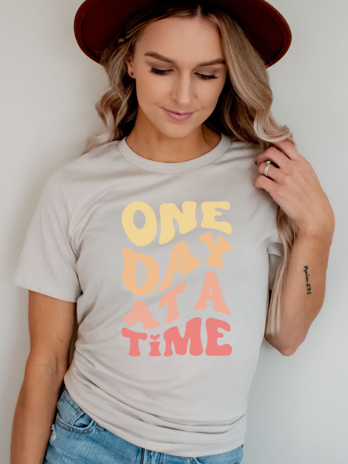 woman wearing One Day At A Time t-shirt