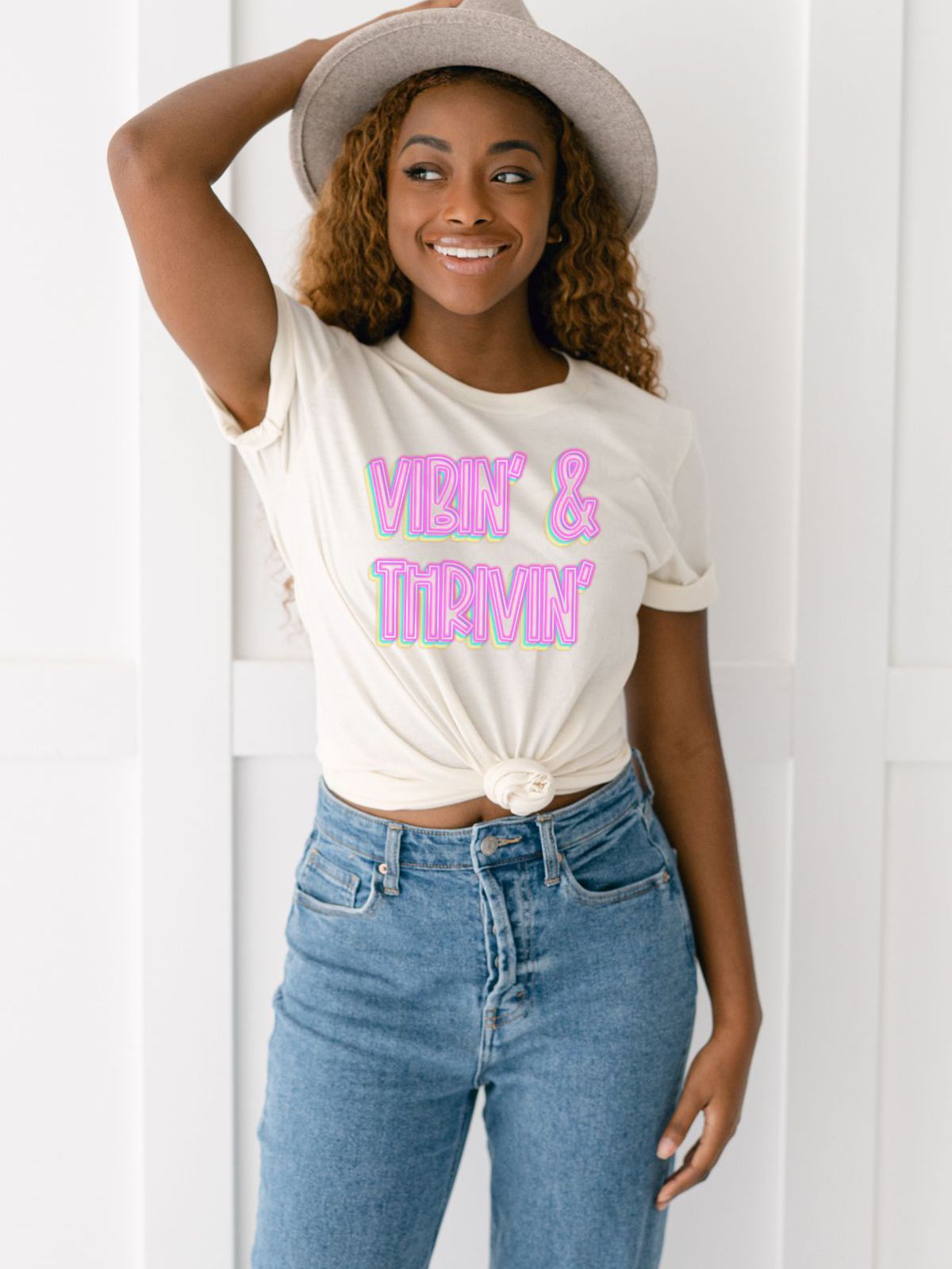 Woman wearing Vibin Thrivin T-shirt and hat