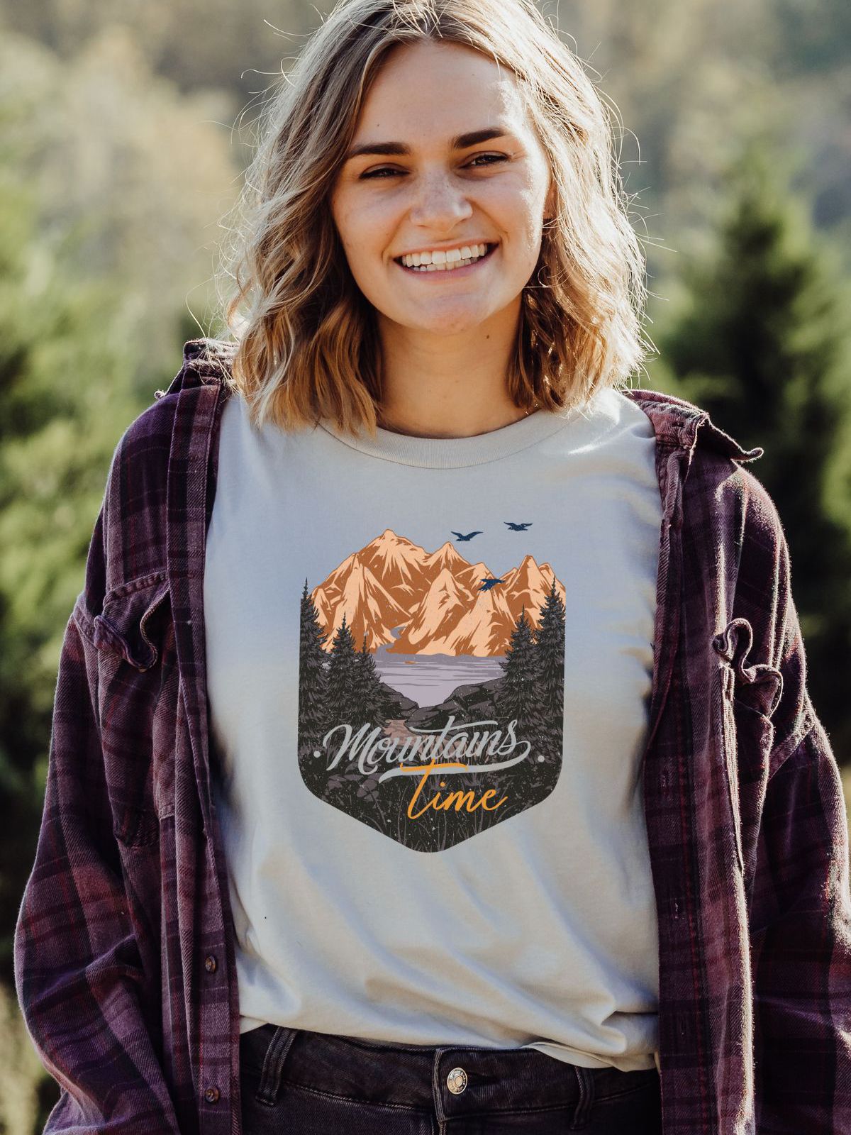 Graphic t-shirt featuring mountains and trees design