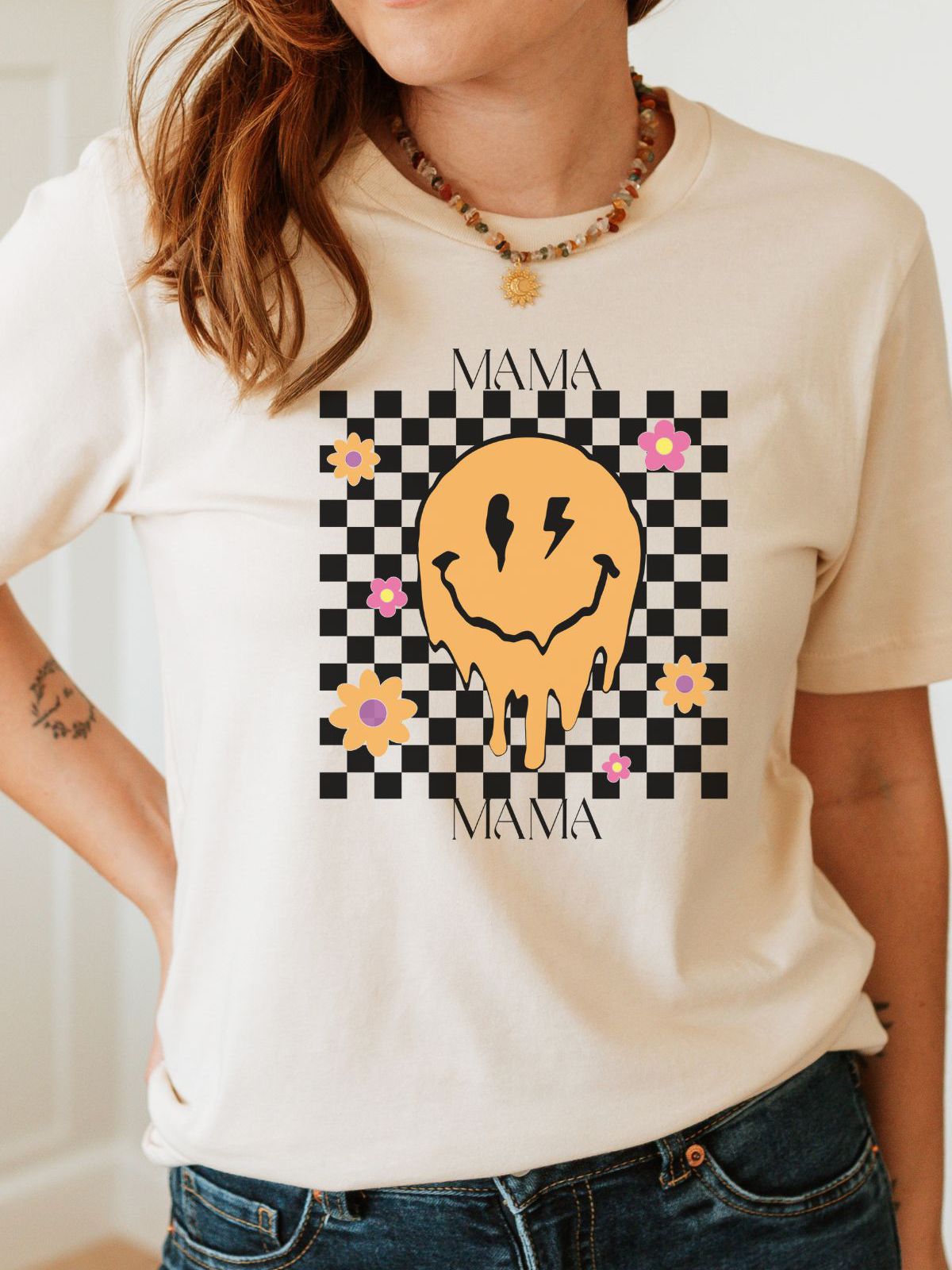 woman wearing a mama smiley face flower t-shirt