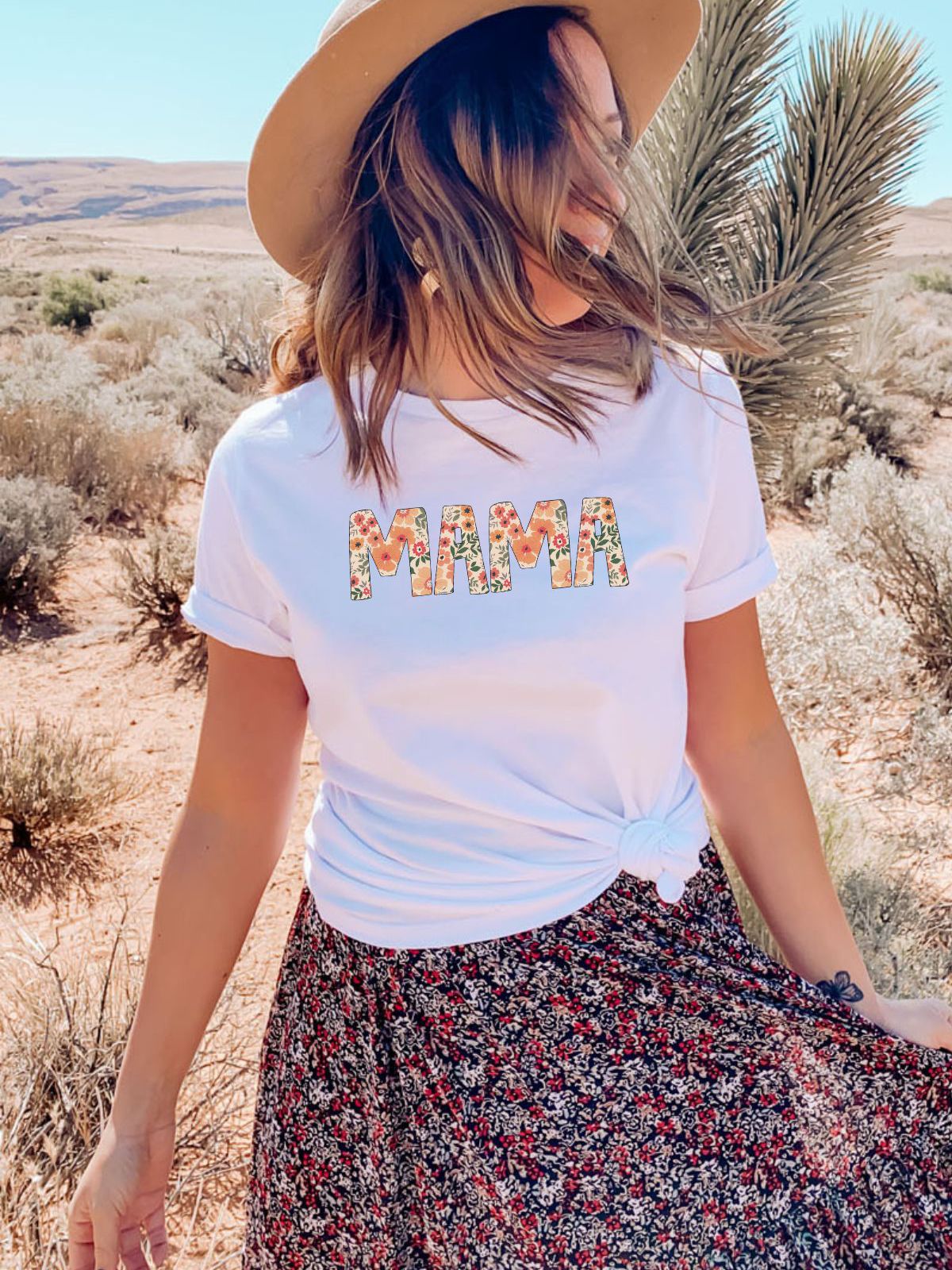 woman wearing floral mama text t-shirt in desert