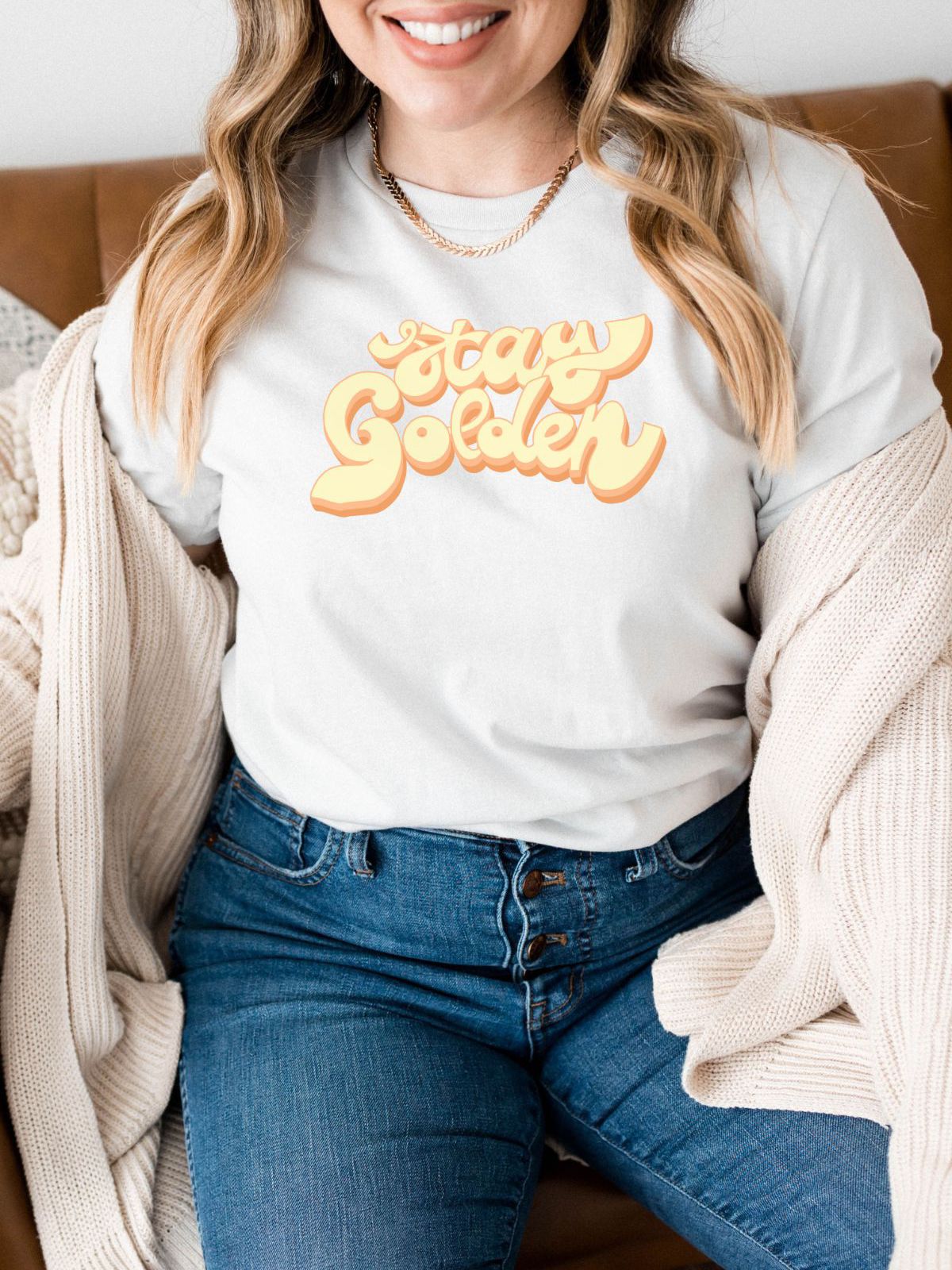 woman wearing white t-shirt with stay golden text