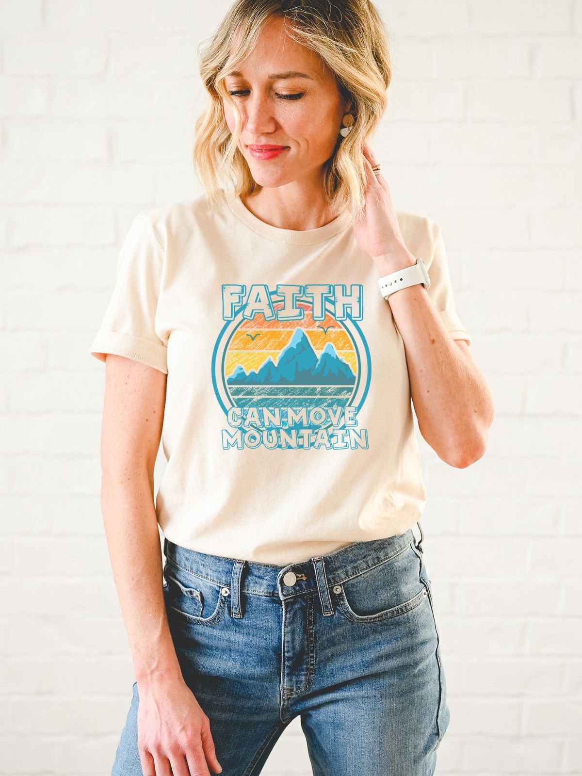 woman wearing faith graphic t-shirt with mountain design