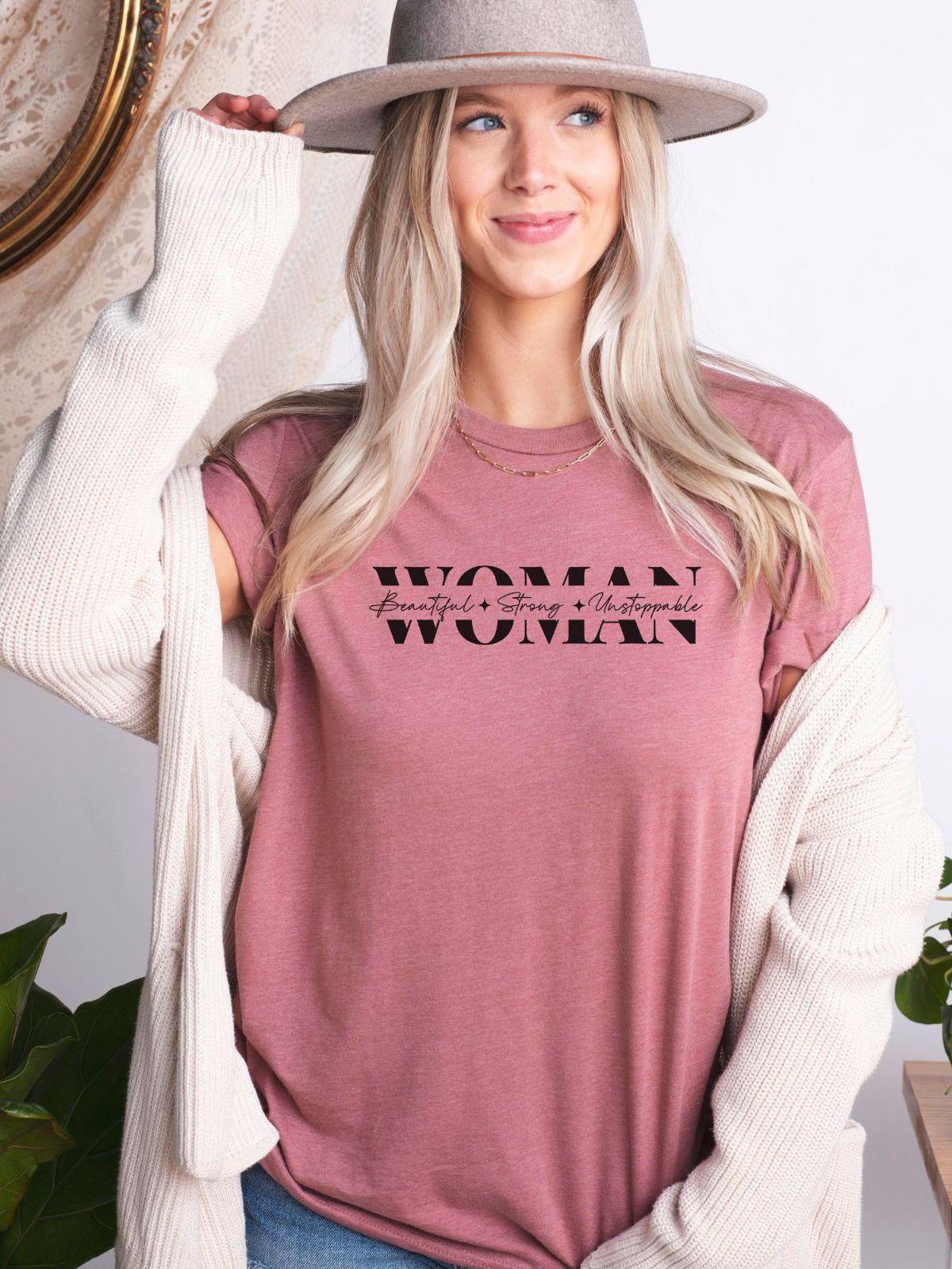 woman wearing pink t-shirt with bold woman text