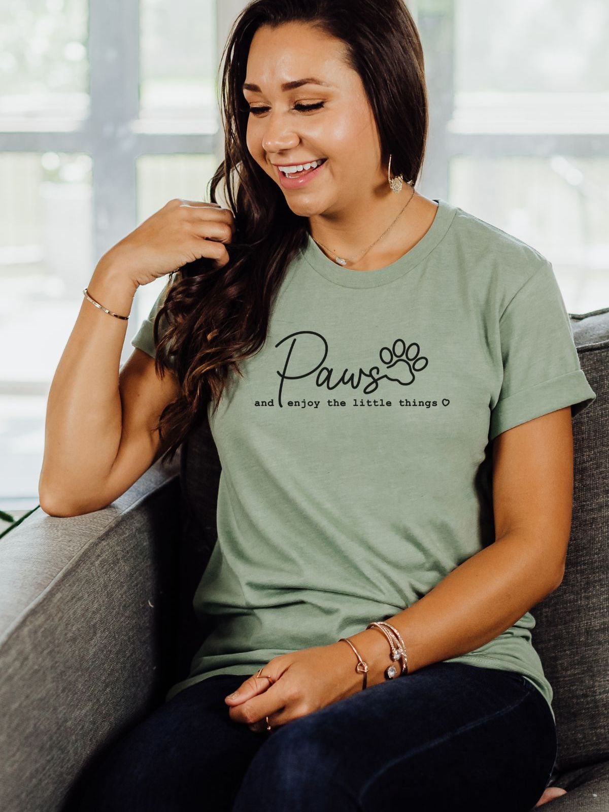 woman wearing a t-shirt with paws and enjoy the little things text
