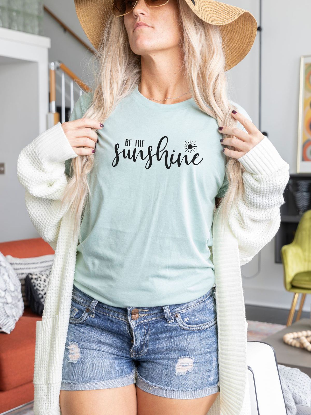 woman wearing Be the Sunshine t-shirt with shorts and hat