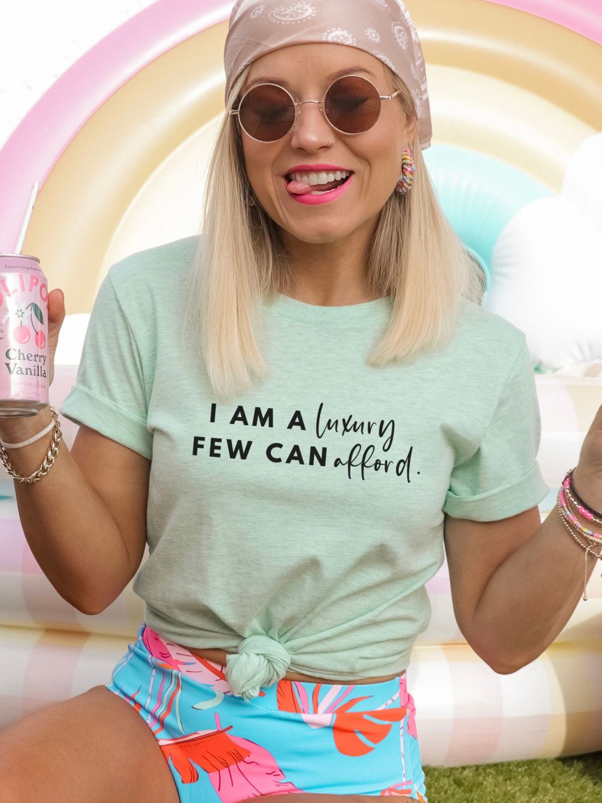 Woman wearing mint green t-shirt with luxury quote