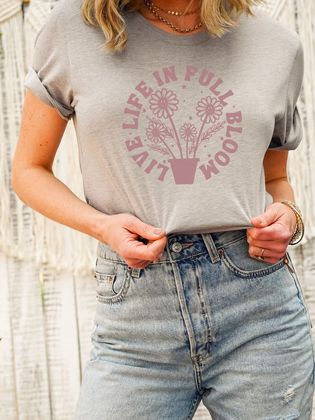 woman wearing a gray t-shirt with Live Life in Full Bloom design
