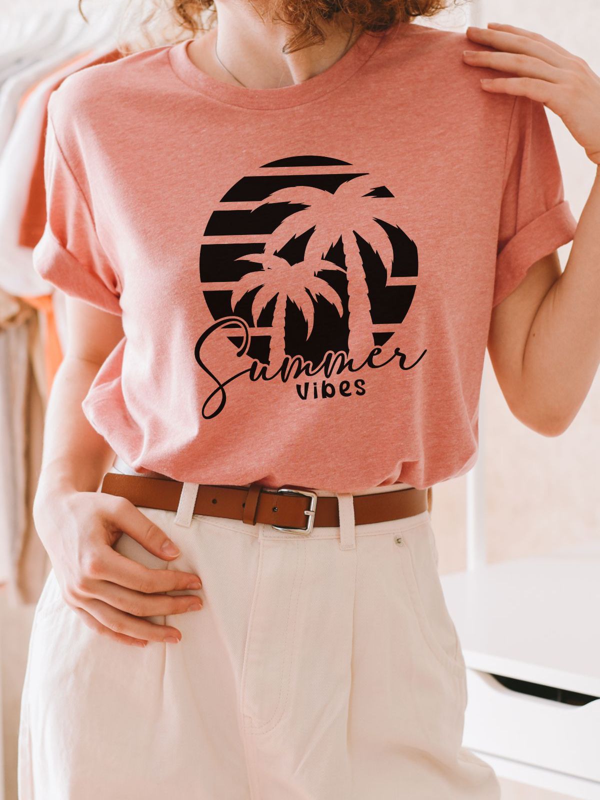 woman wearing pink Summer Vibes t-shirt with palm tree design