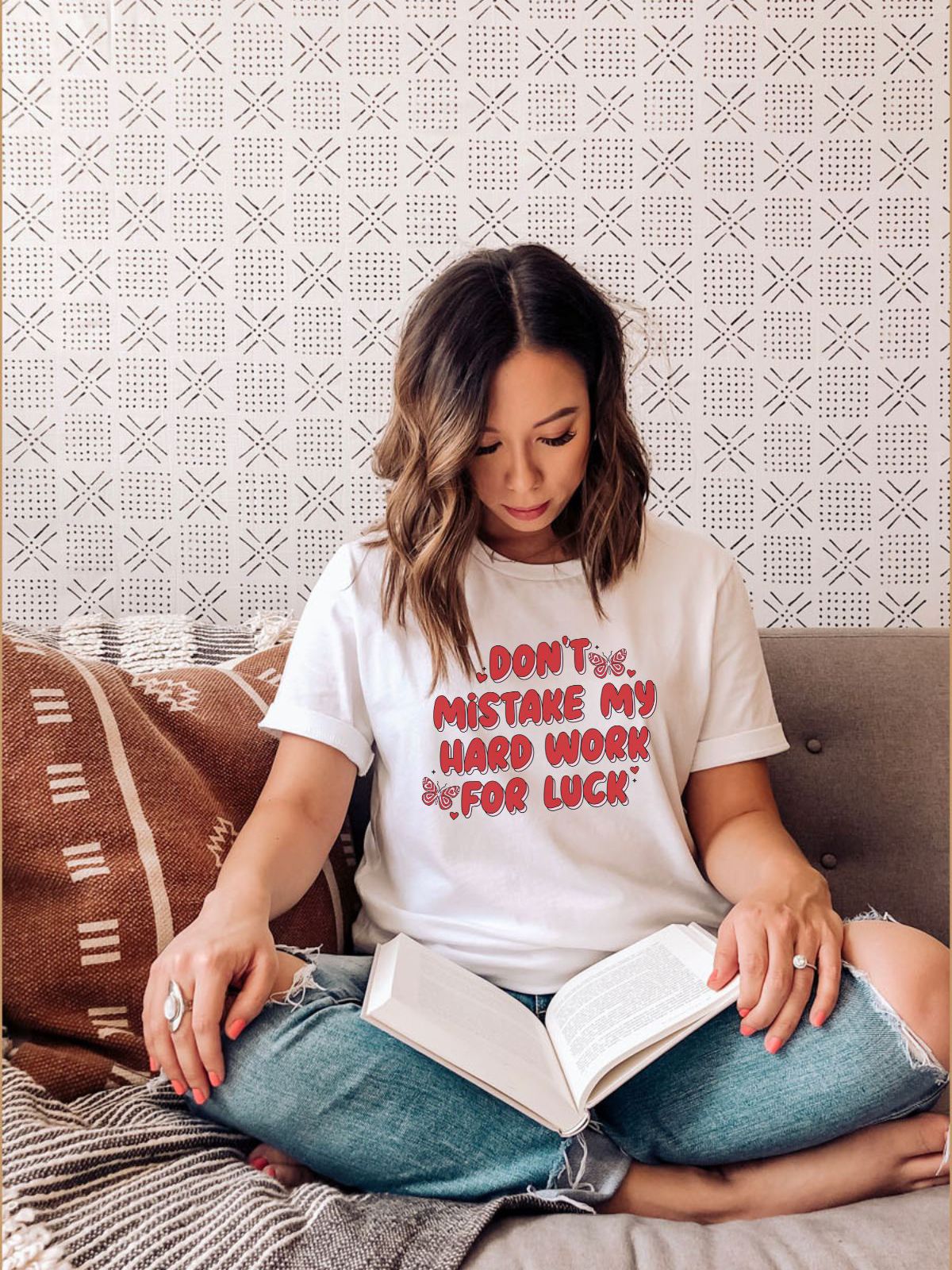 woman wearing t-shirt with text 'don't mistake my hard work for luck'
