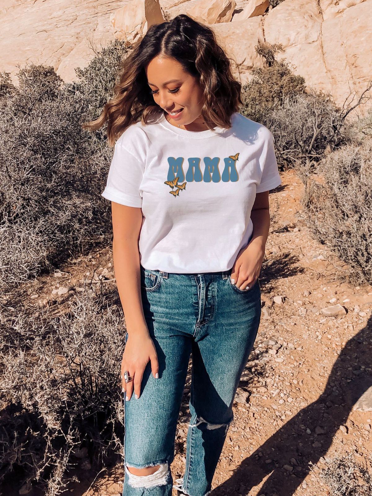 woman wearing a white t-shirt with Mama text and butterflies