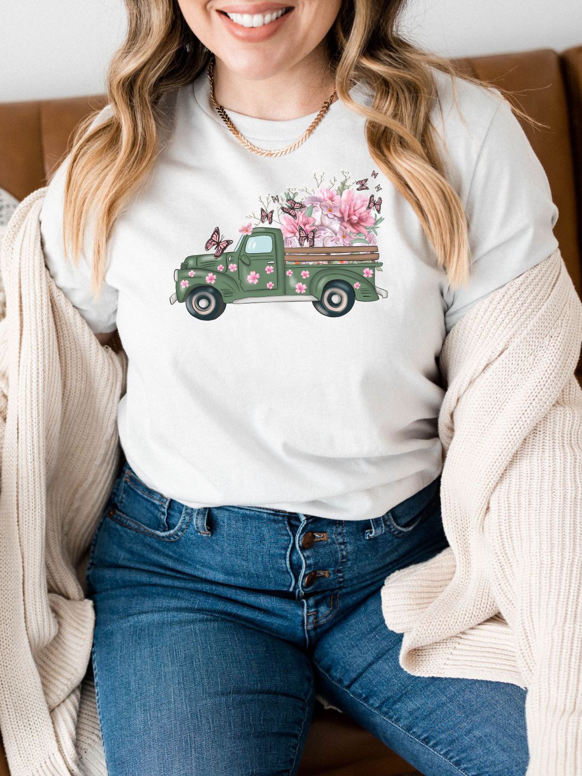 woman wearing a t-shirt with floral truck and butterfly design
