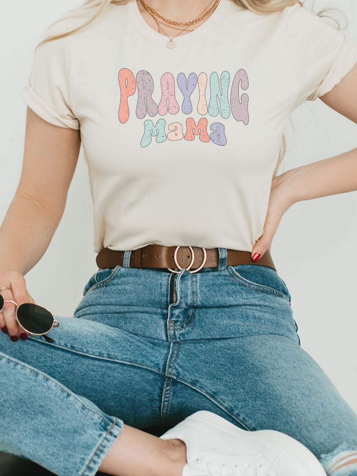 woman wearing a t-shirt with Praying Mama text