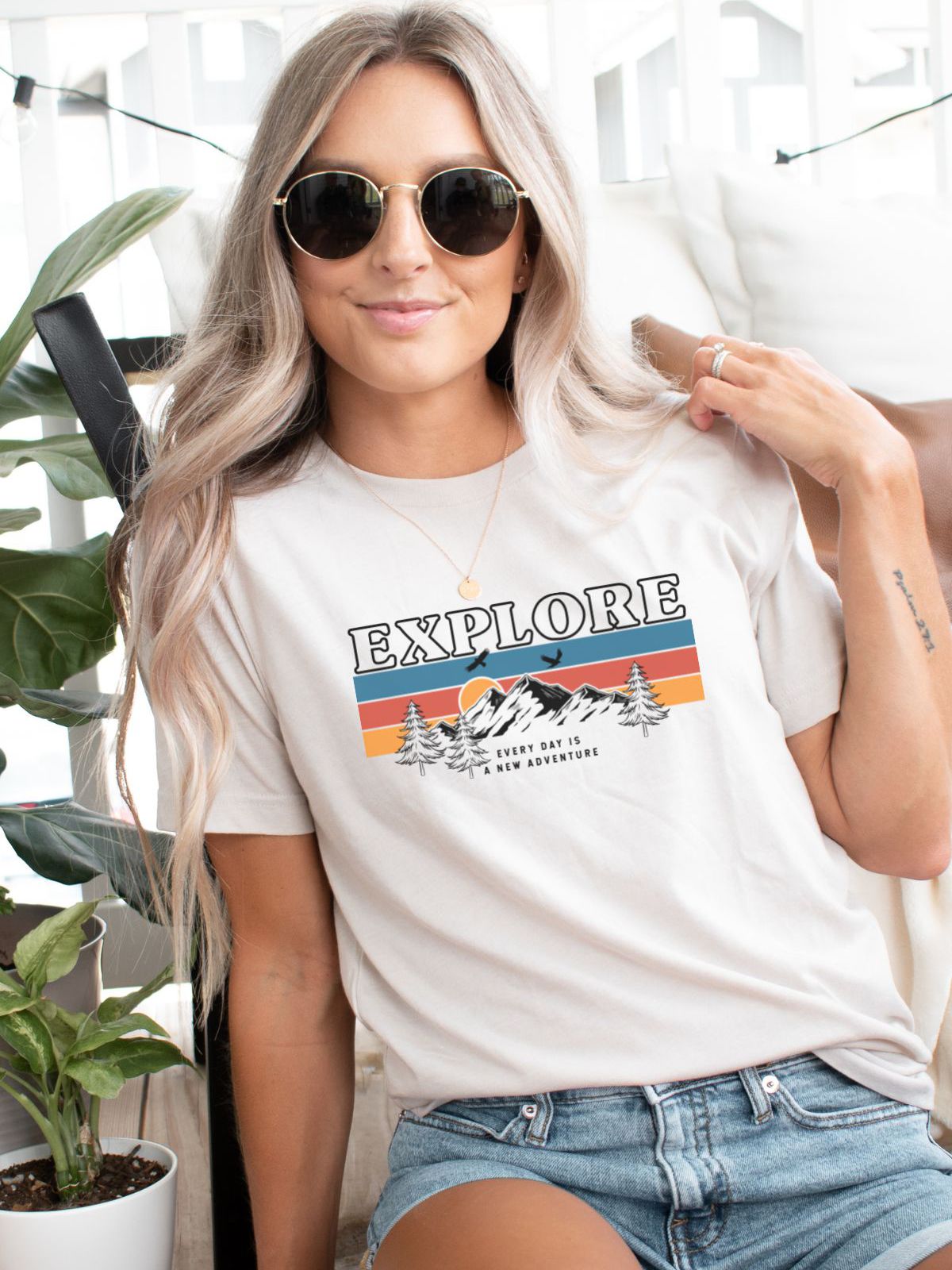 woman wearing explore t-shirt with mountain design