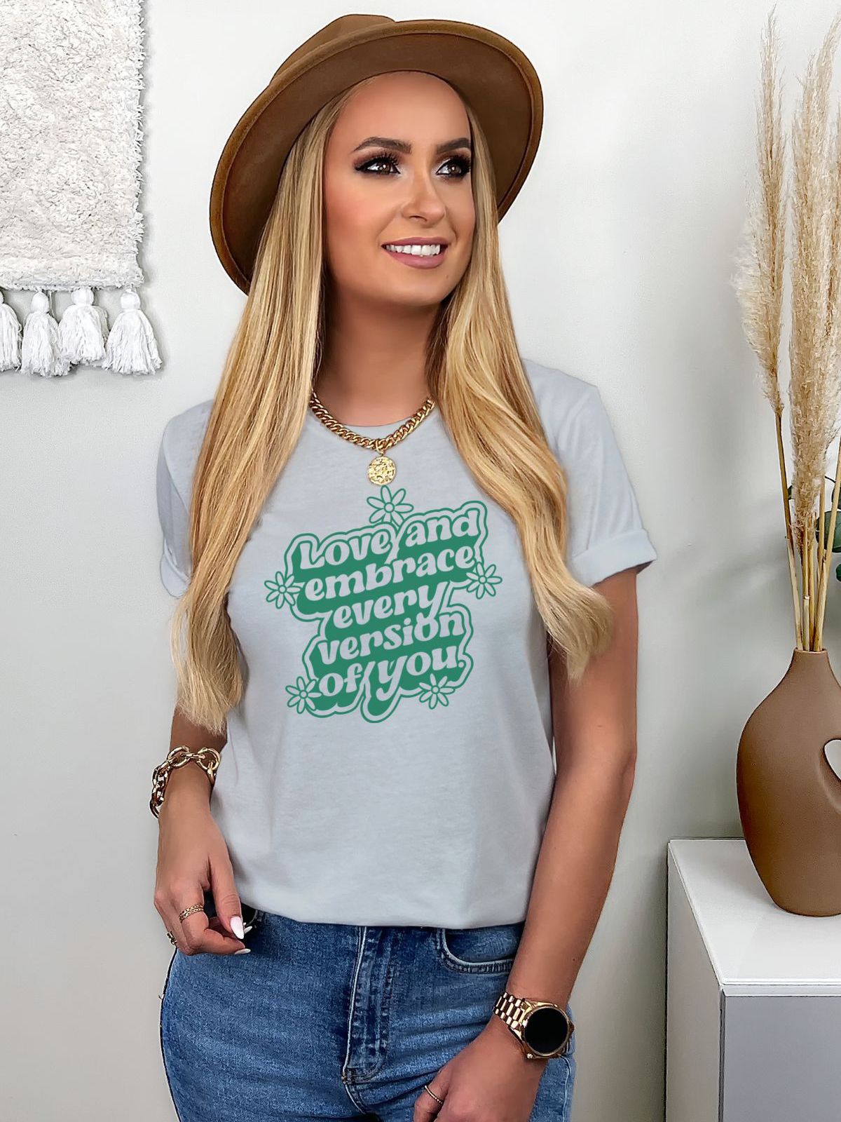 Woman wearing t-shirt with Love and Embrace Every Version of You text