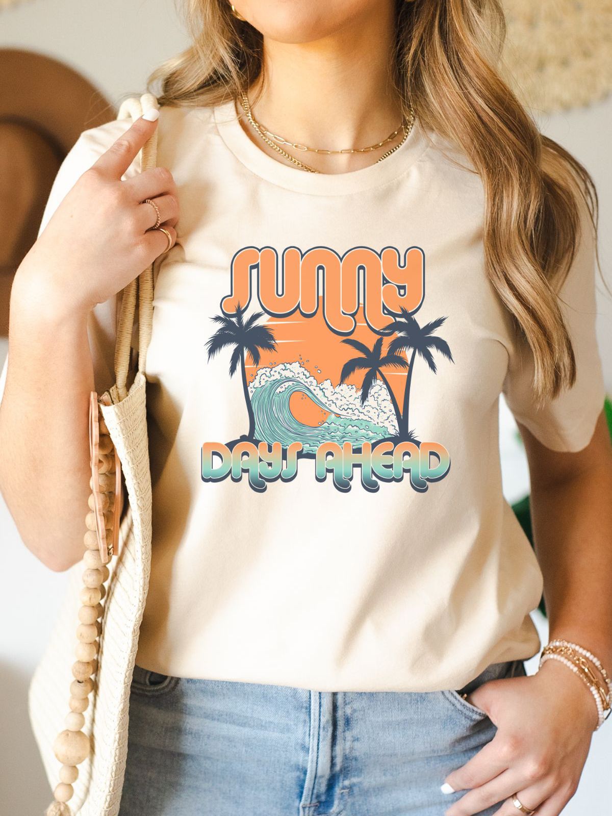Woman wearing Sunny Days Ahead graphic t-shirt with palm trees