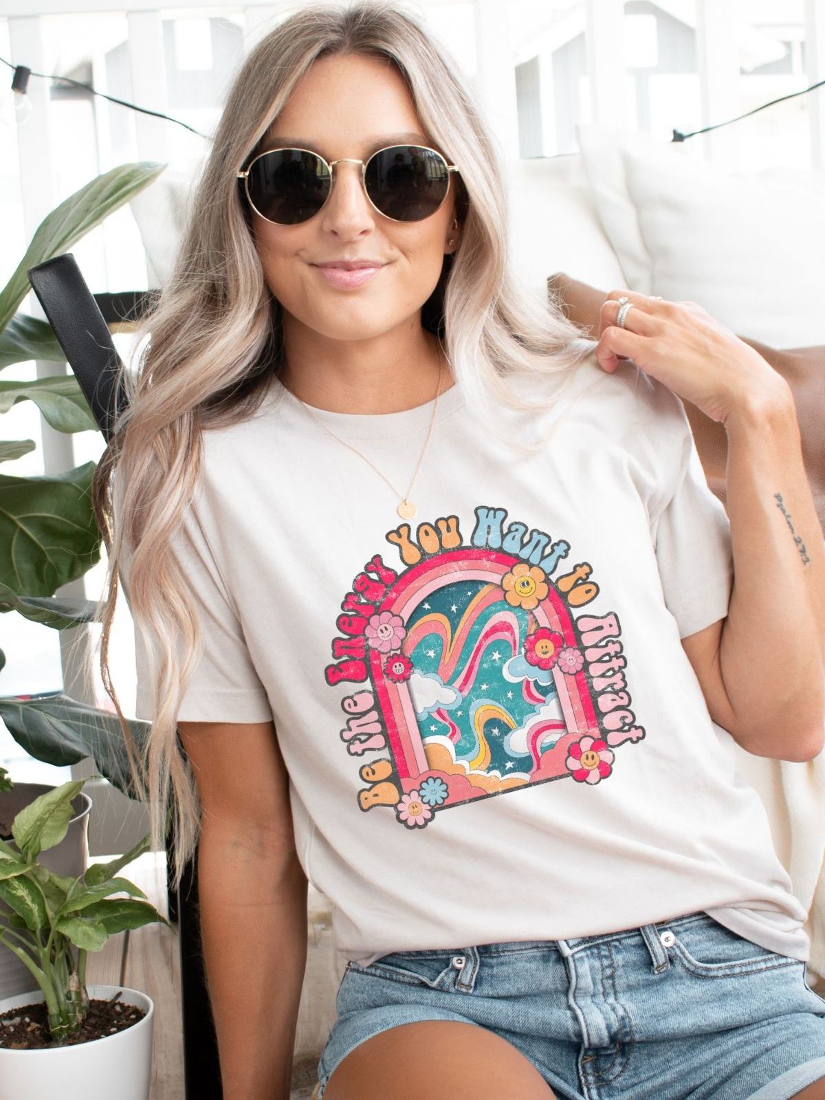 woman wearing a be the energy you want to attract t-shirt
