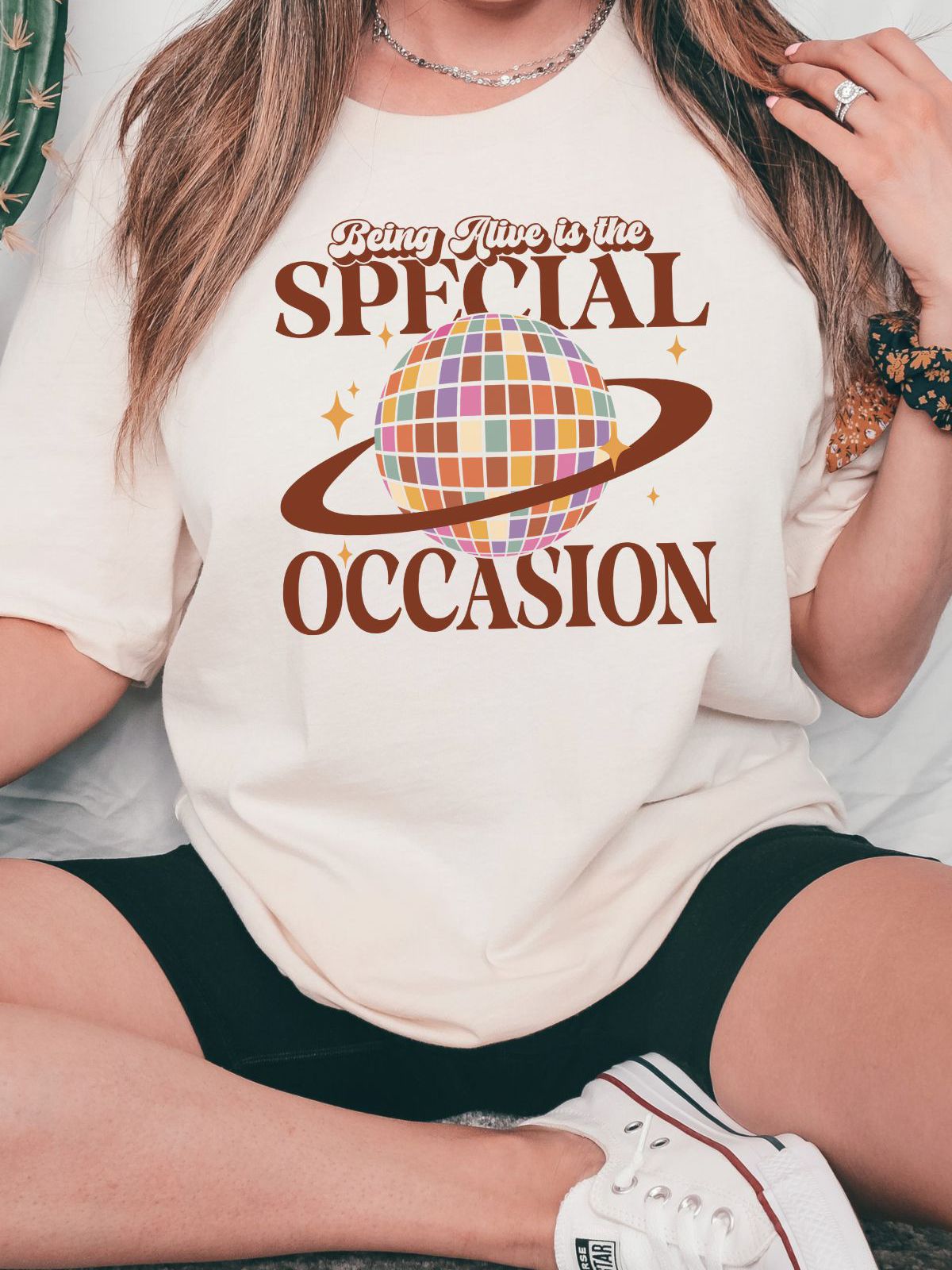woman wearing being alive is the special occasion t-shirt