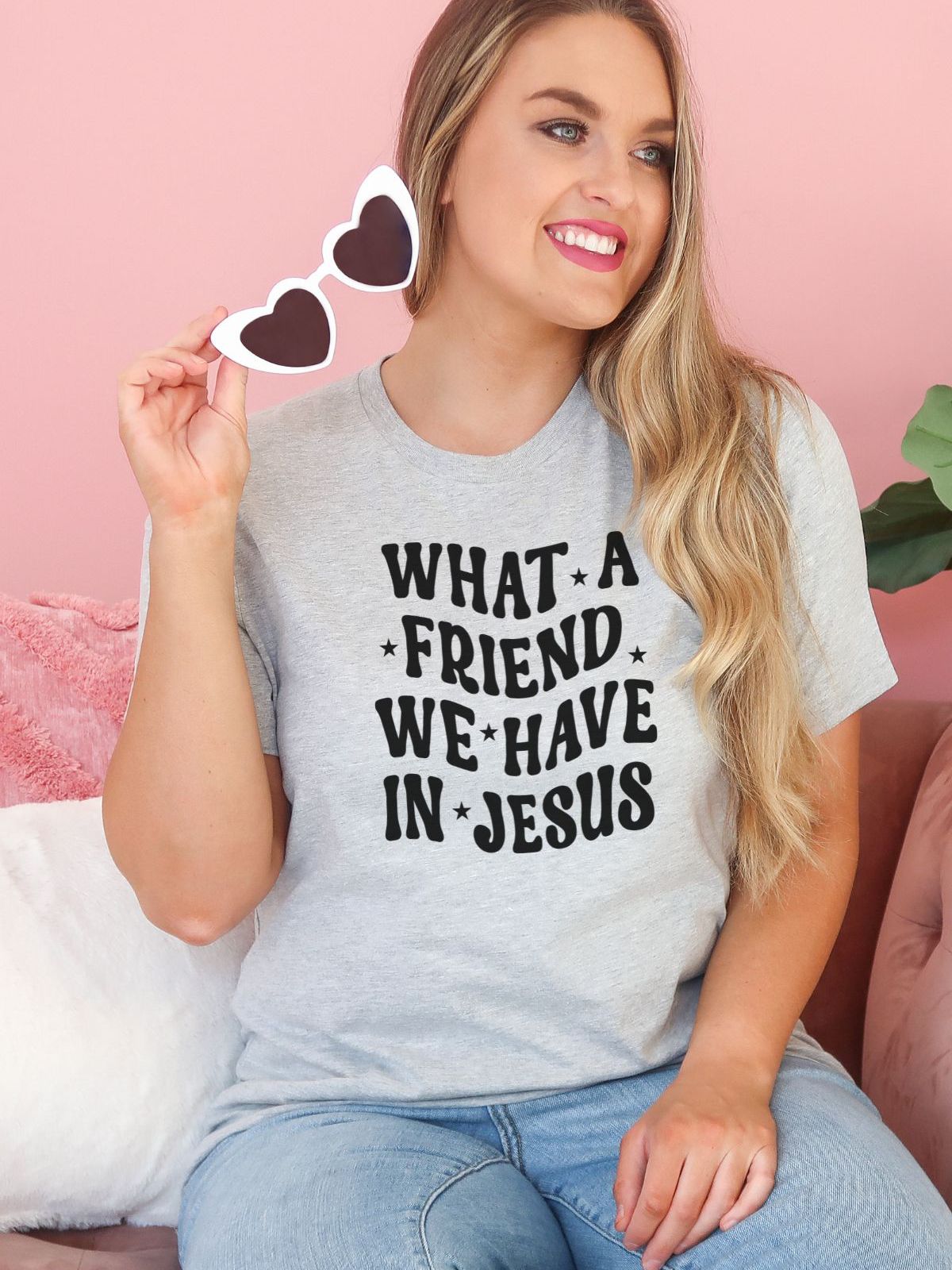 women smiling wearing grey t-shirt with text what a friend we have in Jesus