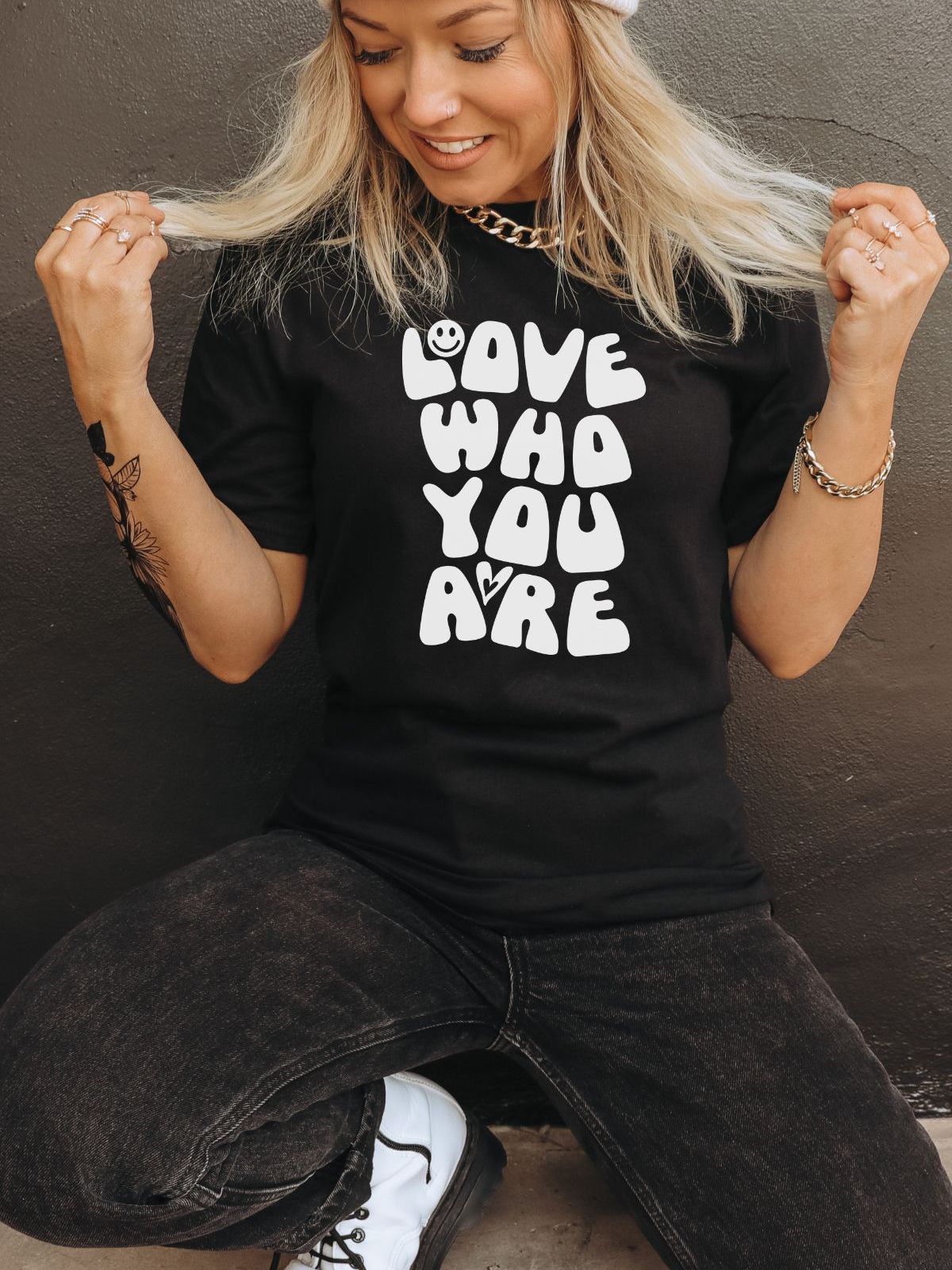 woman wearing black t-shirt with love who you are text
