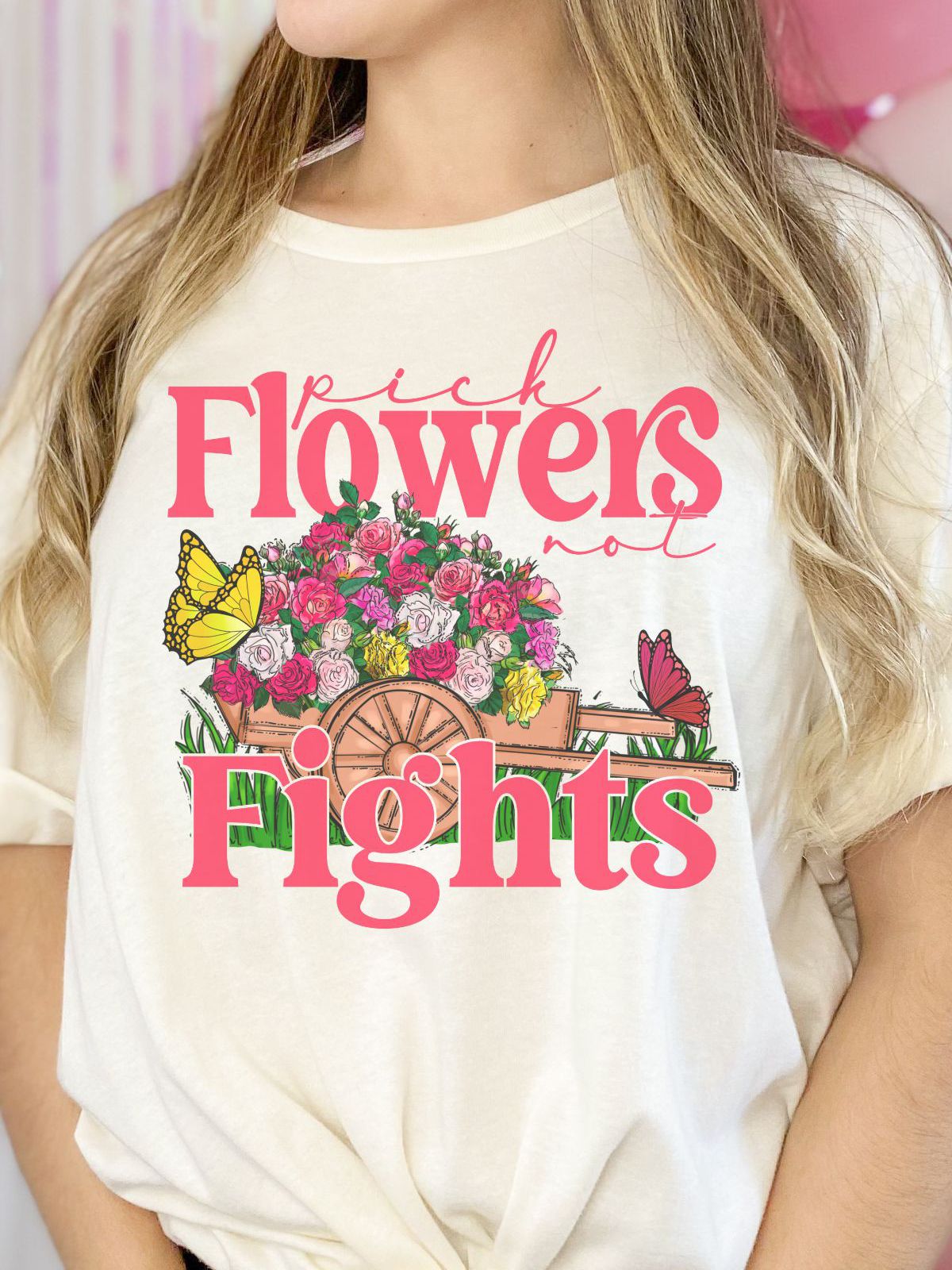 woman wearing t-shirt with pick flowers not fights design